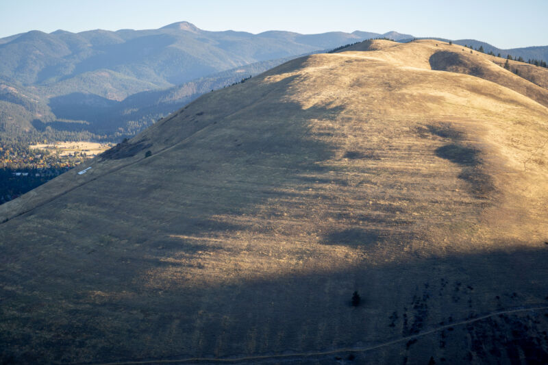 Image of a grassy hillside with a series of natural steps cut into it.