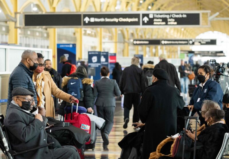 Travelers wait in a terminal at Reagan National Airport during a delay.