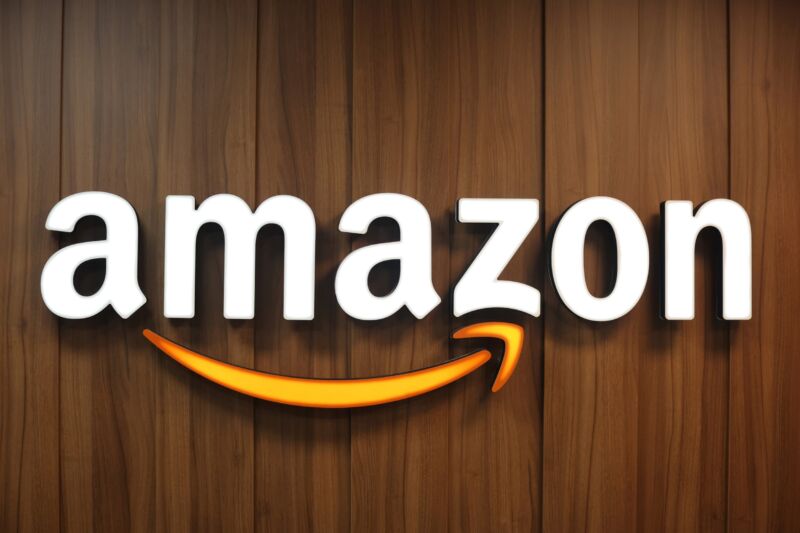 An Amazon sign displayed on a wooden wall inside a company building.