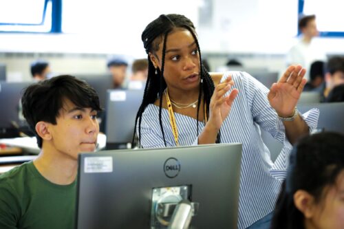 An educator explains a computing concept to a learner.