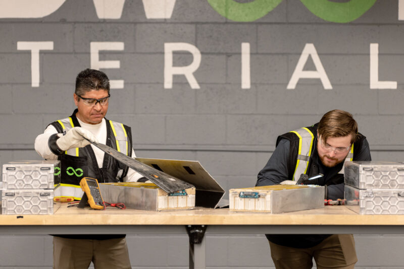 Workers dismantle an EV battery module at Redwood Materials