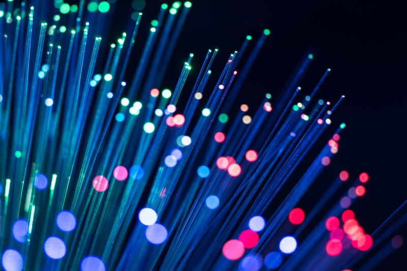 Illustration of fiber cables with colored lights on the ends.