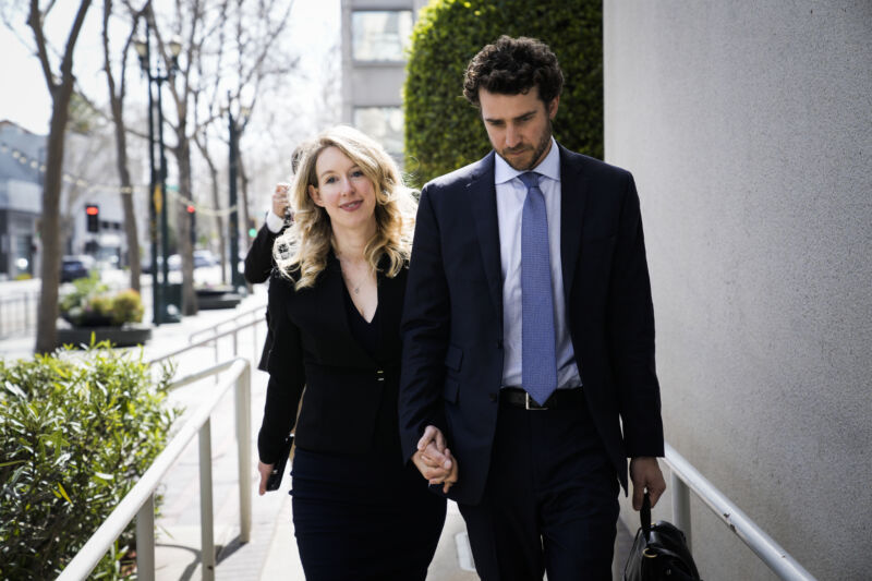 Former Theranos CEO Elizabeth Holmes alongside her partner Billy Evans, leaves a hearing at the Robert E. Peckham US Courthouse on March 17, 2023, in San Jose, California.