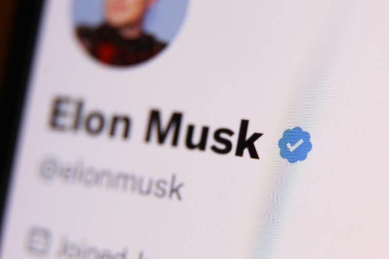The blue checkmark on Elon Musk's Twitter profile displayed on a phone screen