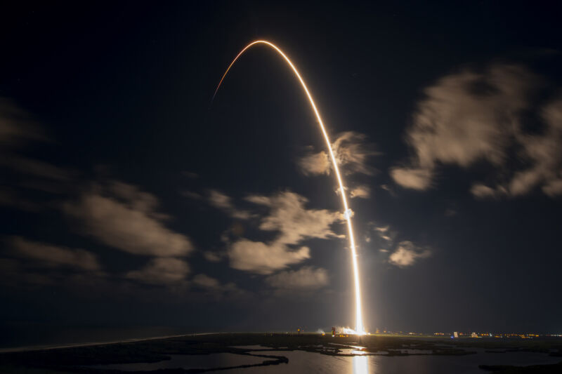 A Falcon 9 rocket climbs into orbit from Cape Canaveral, Florida, with 22 Starlink satellites Tuesday night in this long-exposure photo.