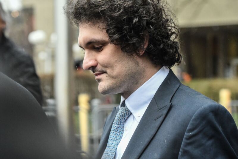 Sam Bankman-Fried pictured from the side as he leaves a courtroom.