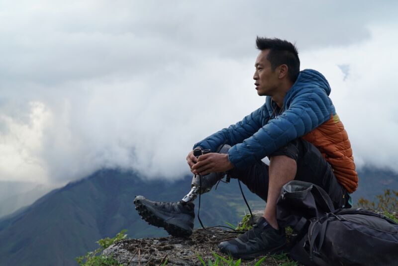 NatGeo Explorer Albert Lin sits on the edge of a cliff in Peru