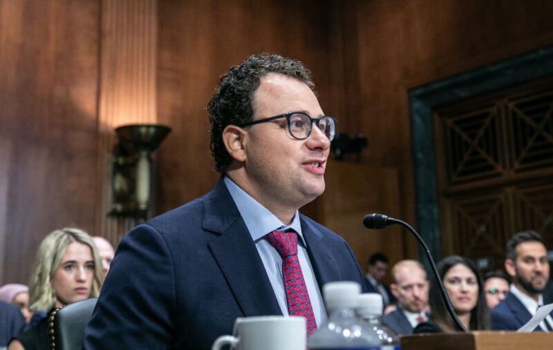 Anthropic CEO Dario Amodei sitting at a table and speaking into a microphone during a Senate committee hearing.