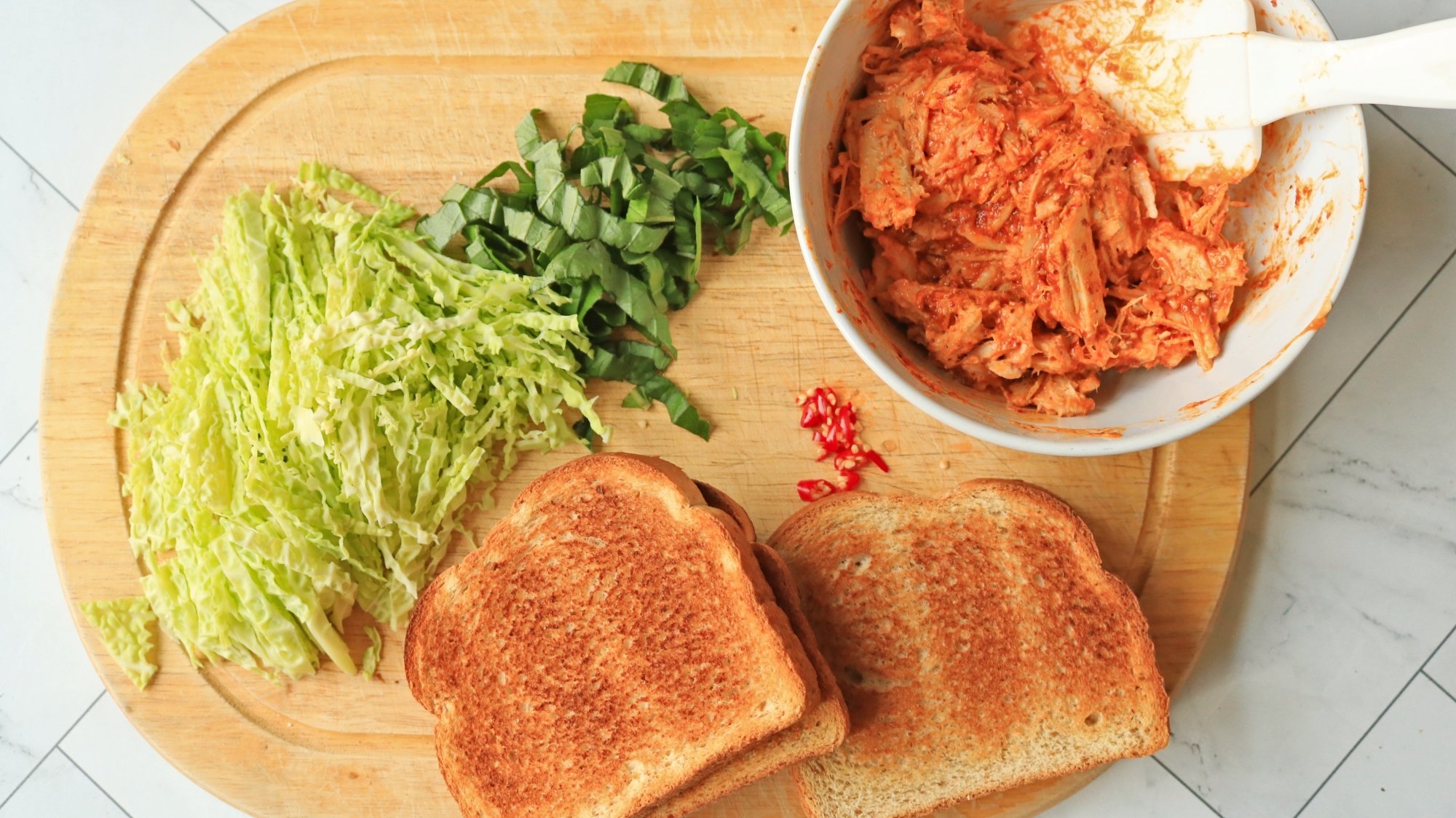 Ingredients for a sandwich on a cutting board