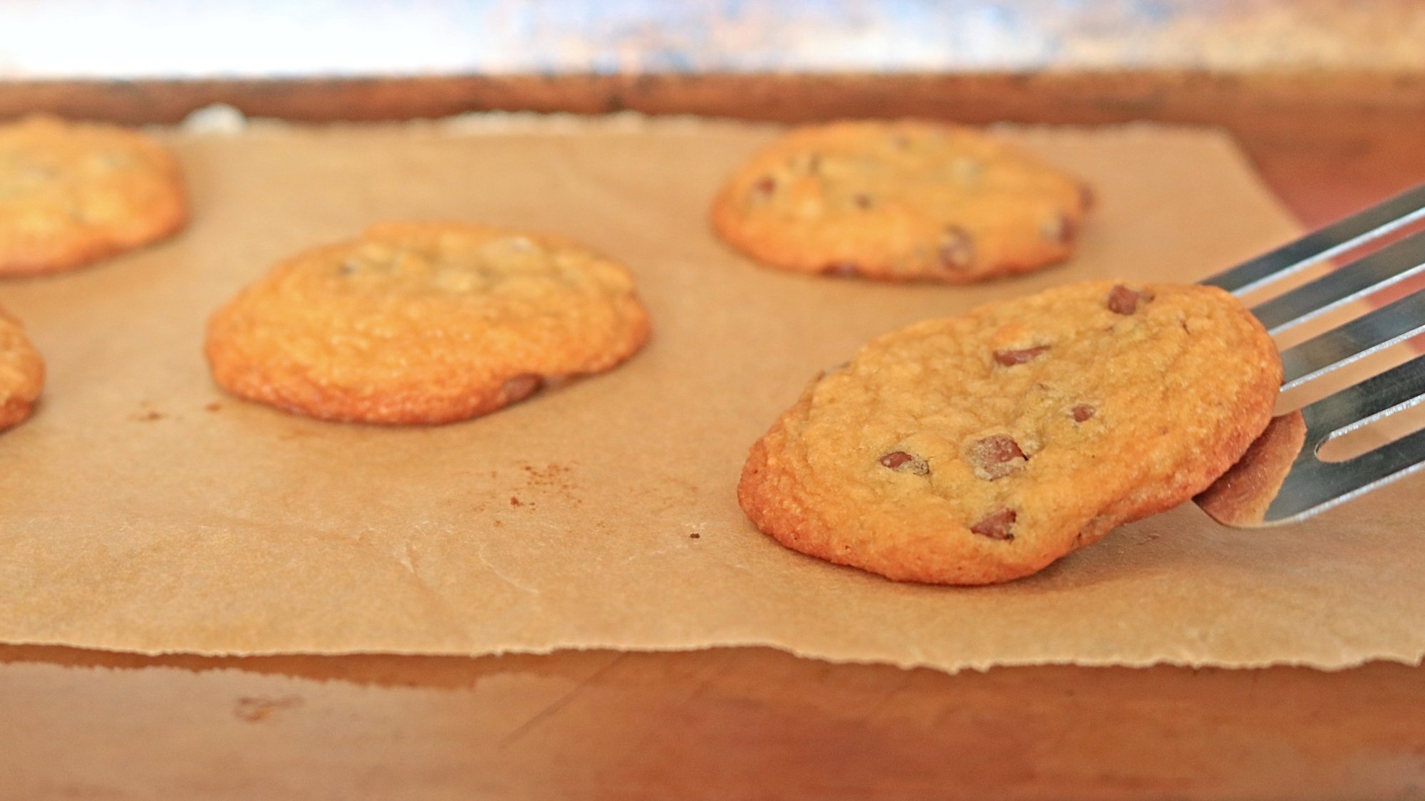Spatula scooping a cookie up-close.