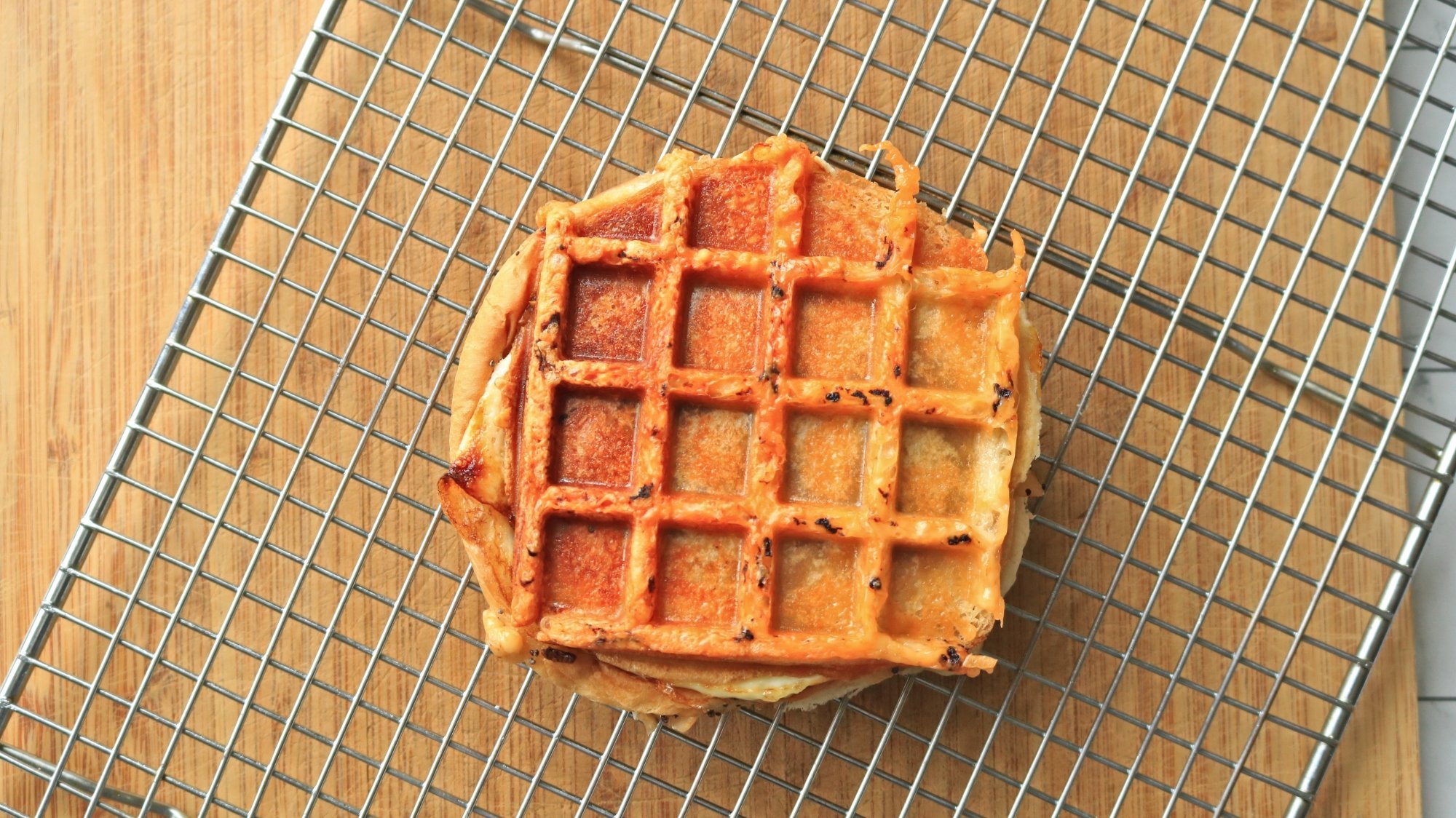 Waffled sandwich on a wire cooling rack.