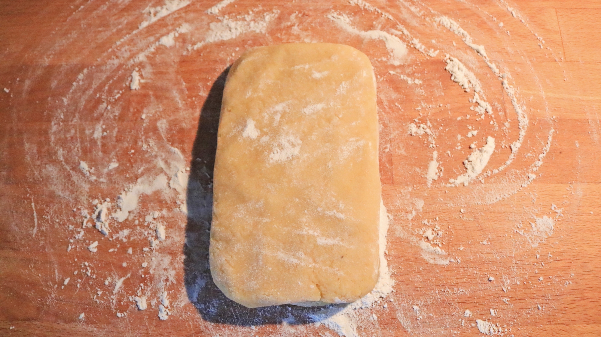 Rectangle of dough on a cutting board.