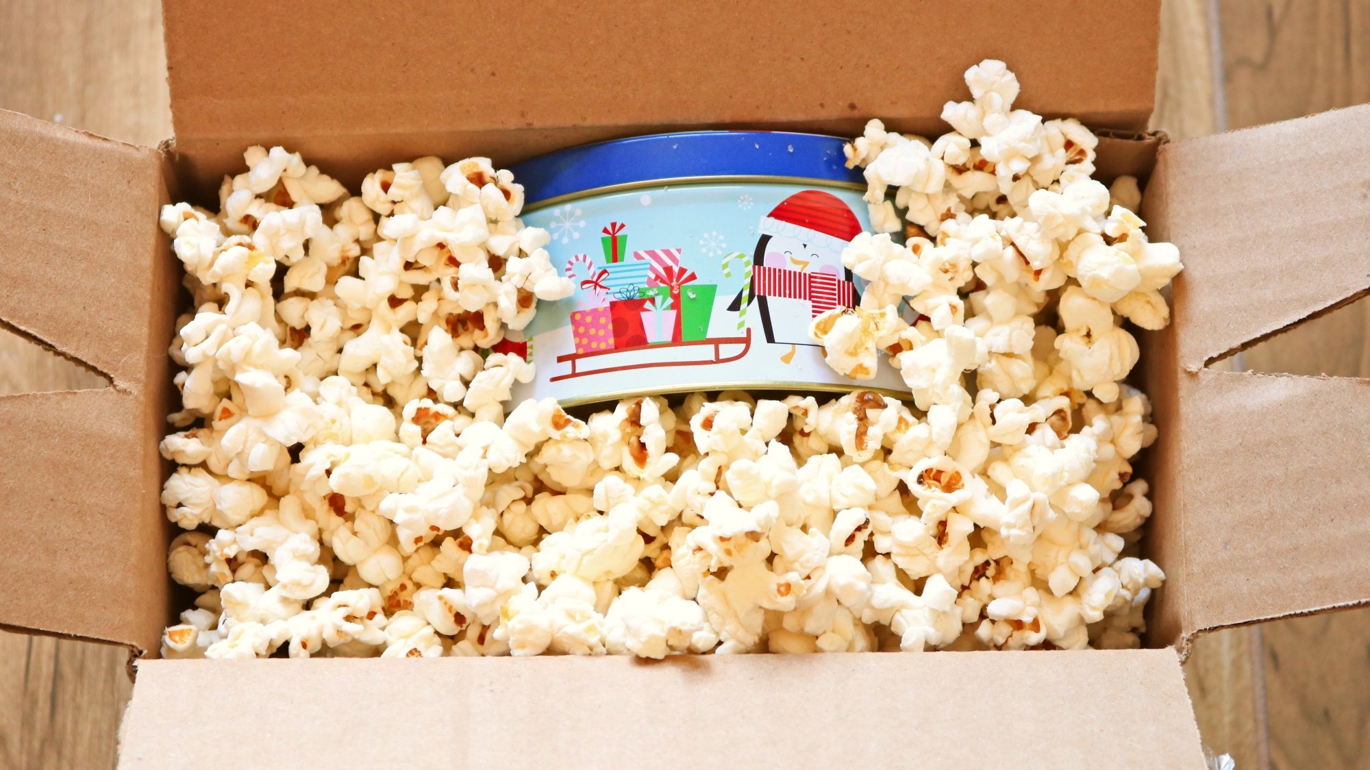 Cookie tin in a box full of popcorn.