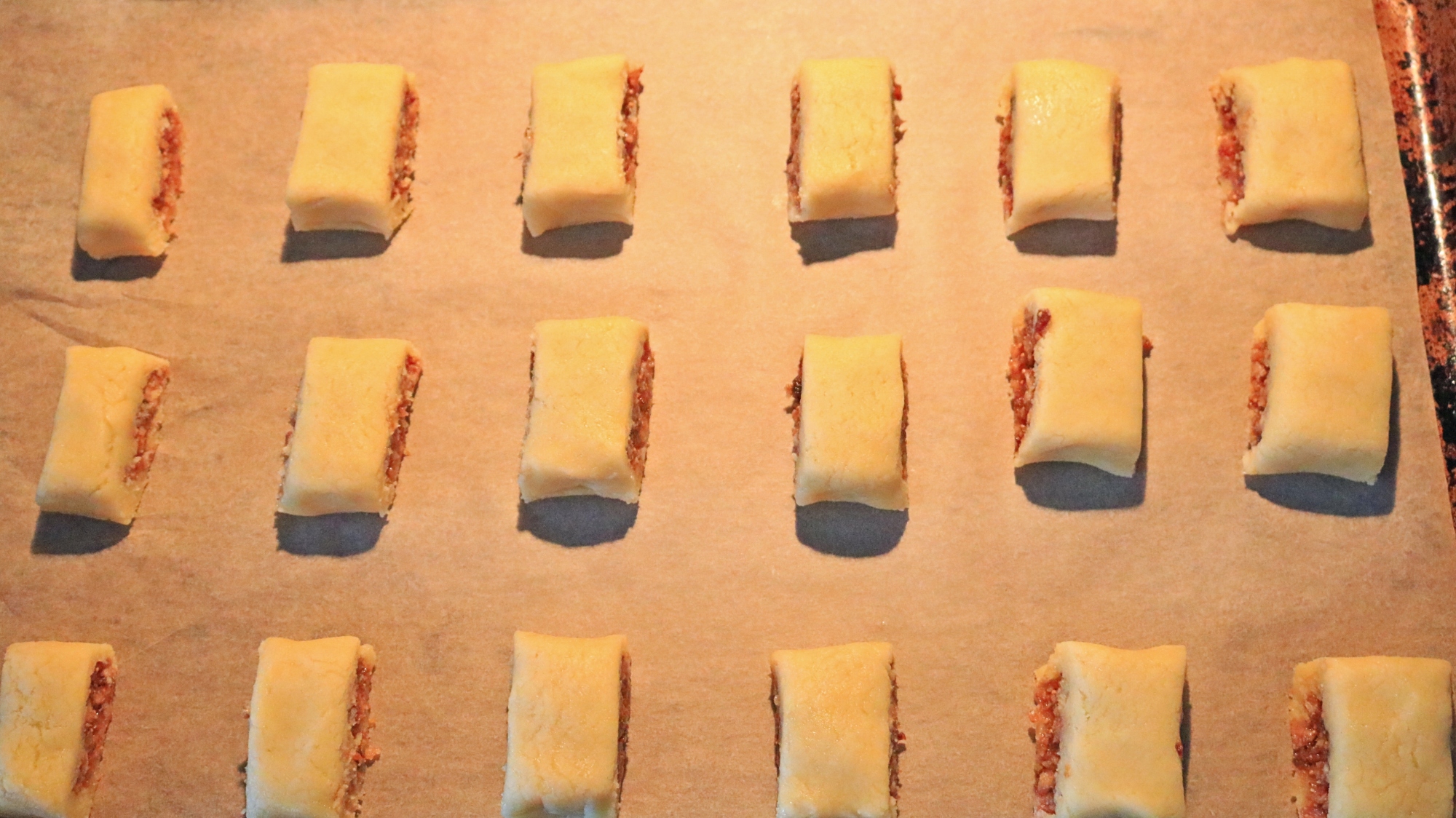 Fig filled cookies on a sheet tray.