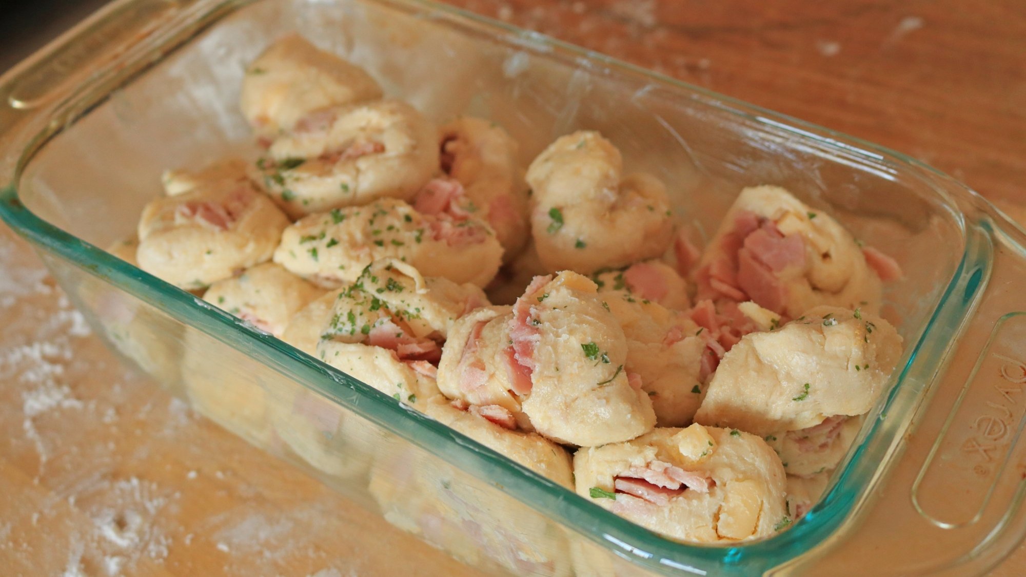 Raw dough balls in loaf pan before baking