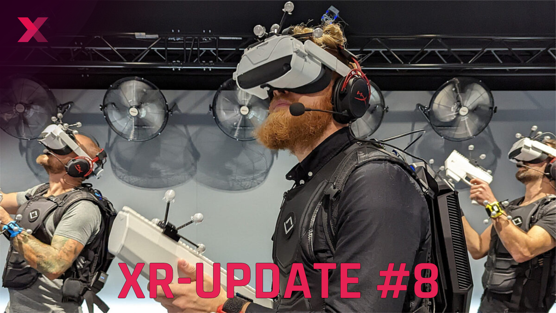 Three bearded men with VR headsets and plastic guns.