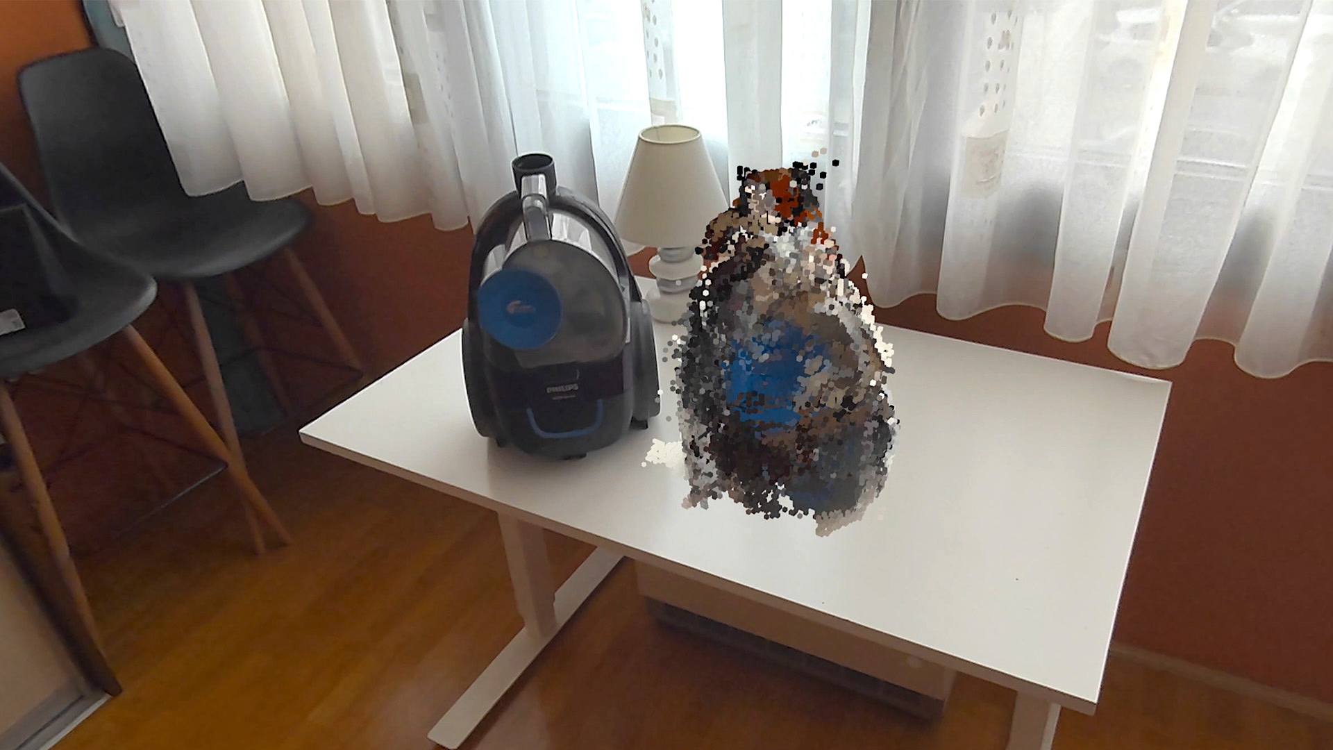 A real vacuum cleaner next to the copy scanned with Quest 3, which appears as a pile of voxels.
