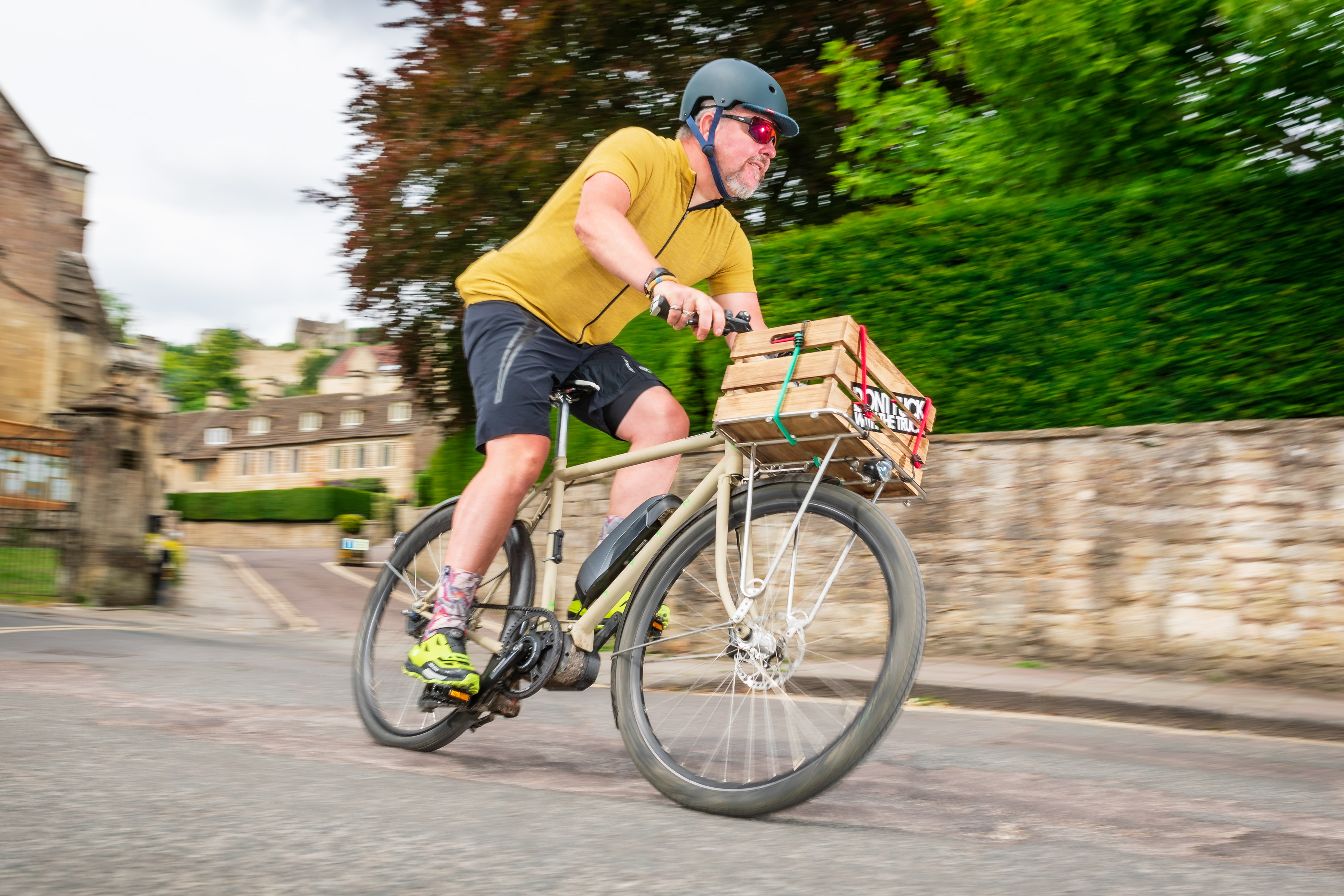 Man riding an electric bike with a box on the front