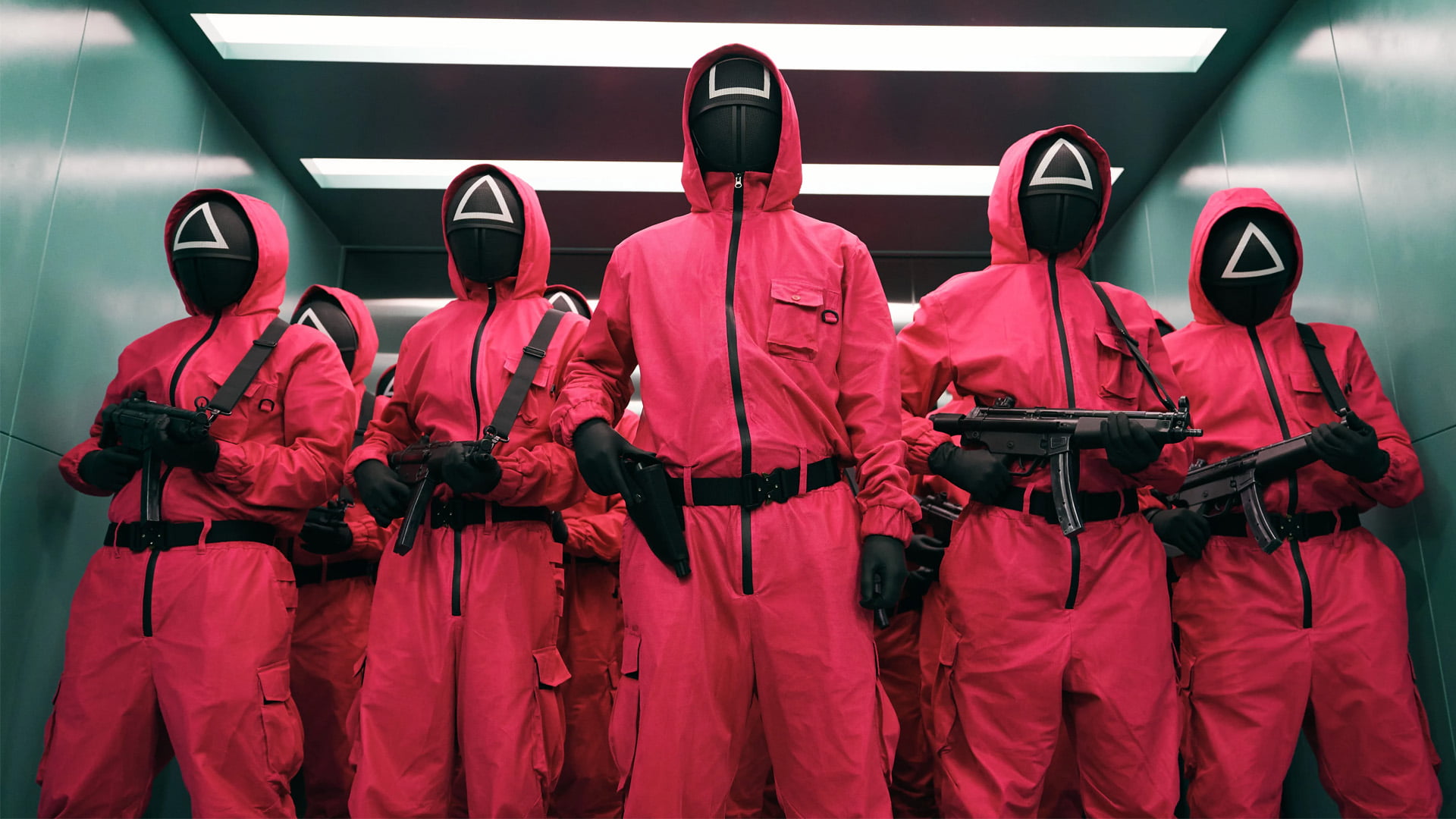 Armed guards from Squid Game in red suits and black masks.
