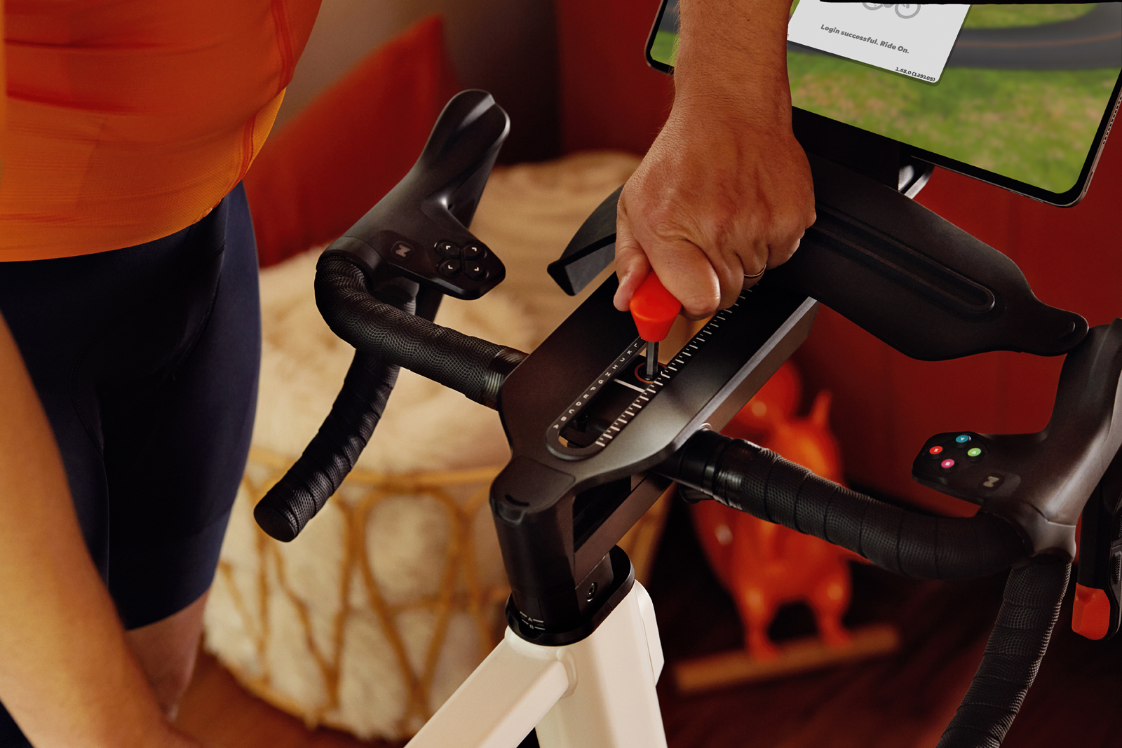Hand adjusting reach on Zwift Ride smart bike with Zwift Key.