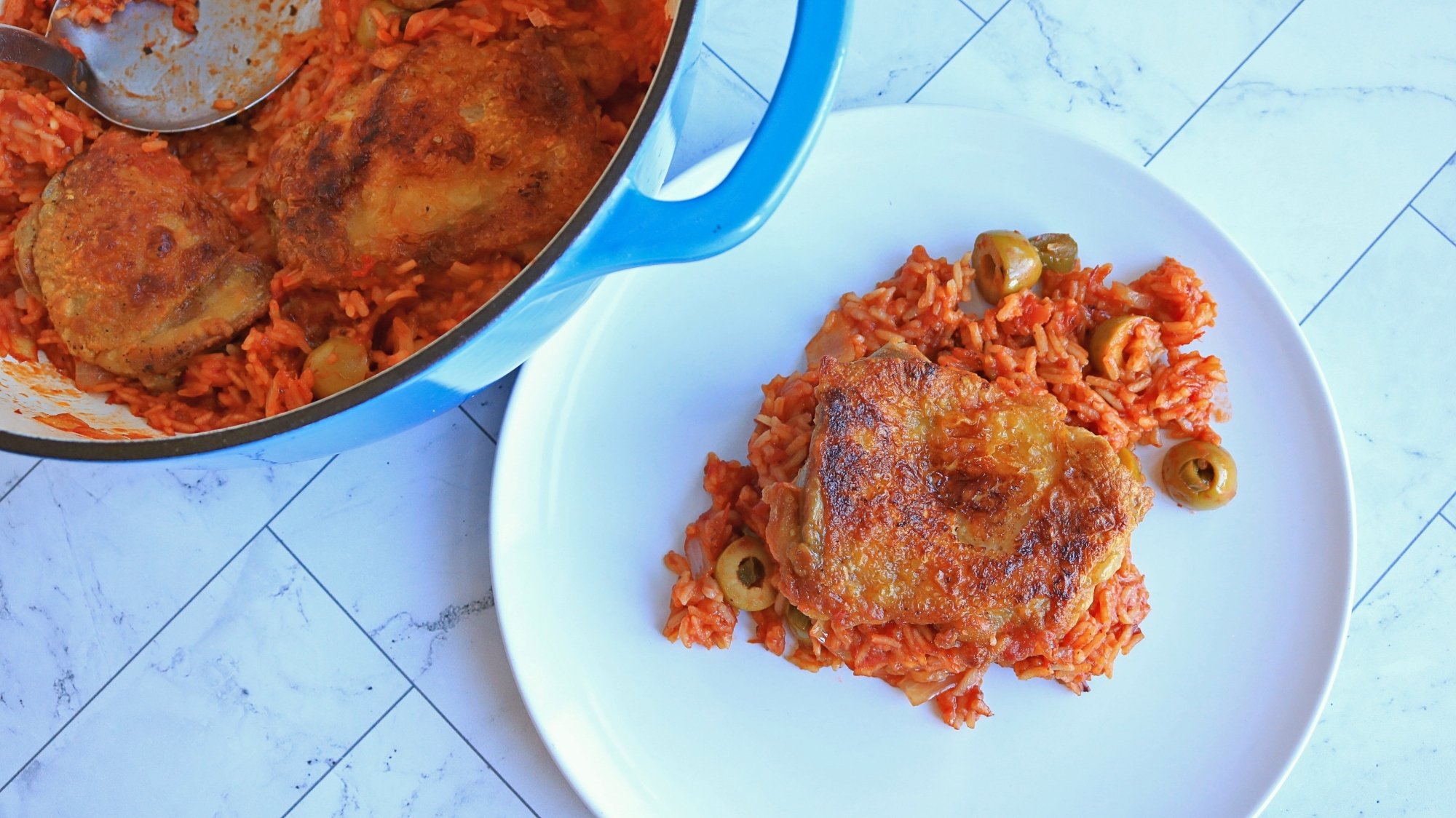 A plate of chicken and tomato rice.