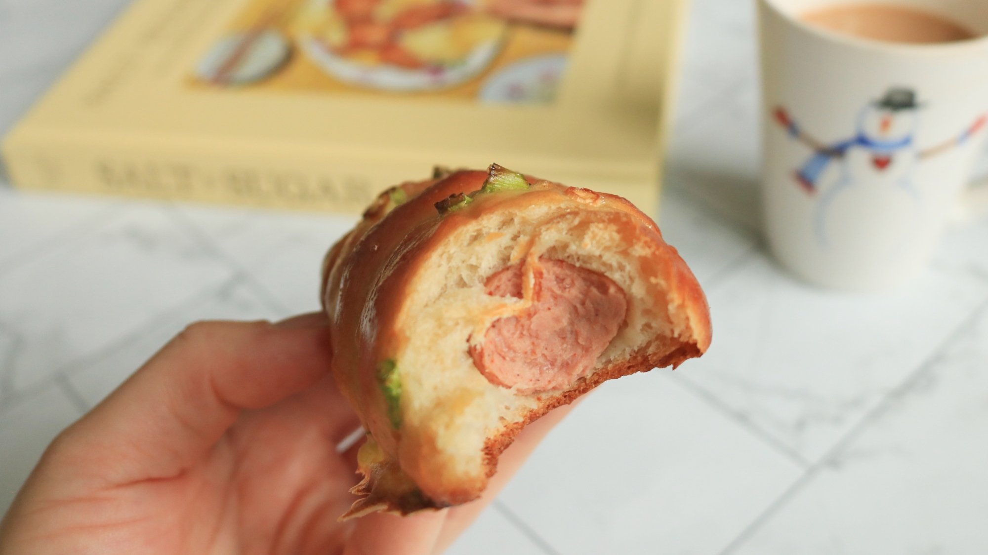 A bitten hot dog scallion bun.