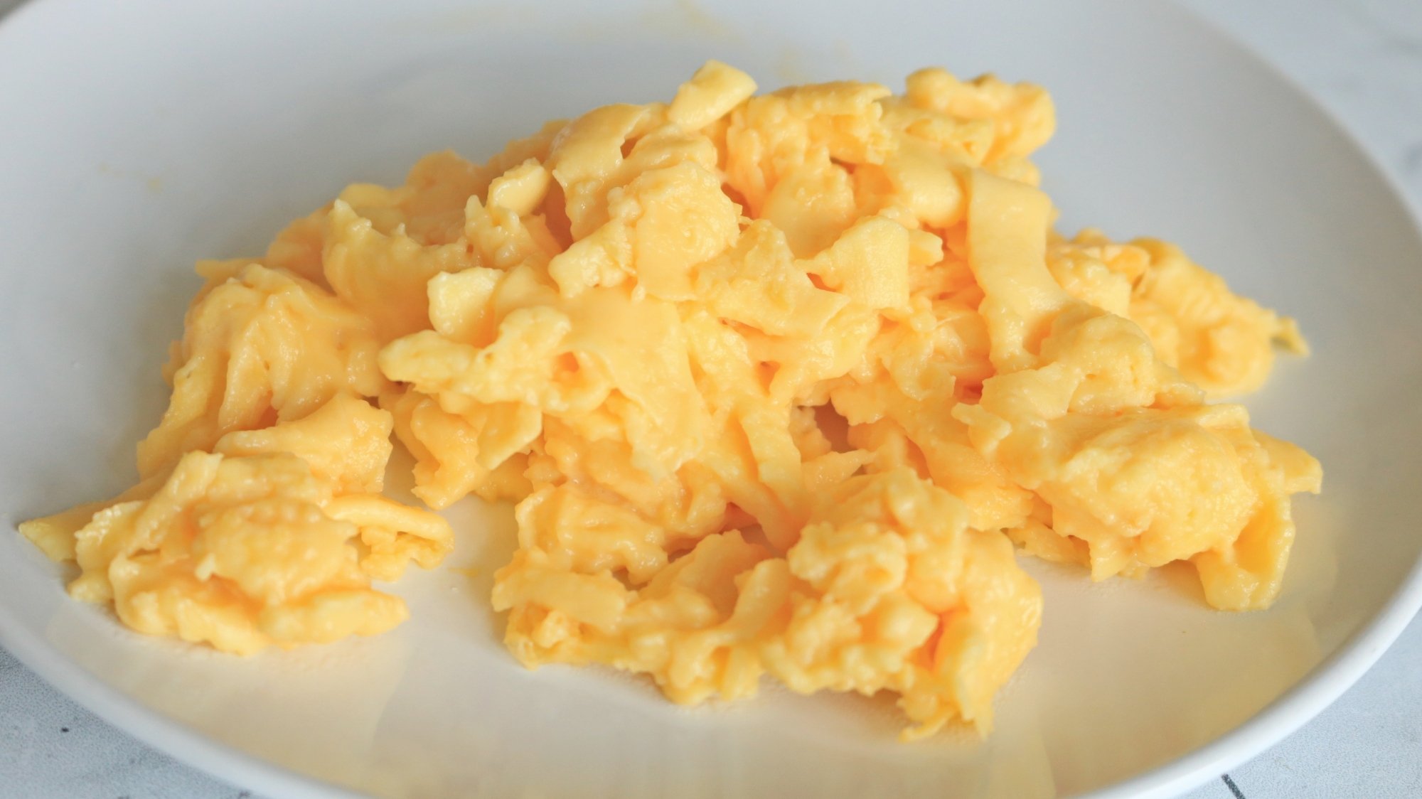 Immersion blender-scrambled eggs on a white plate.