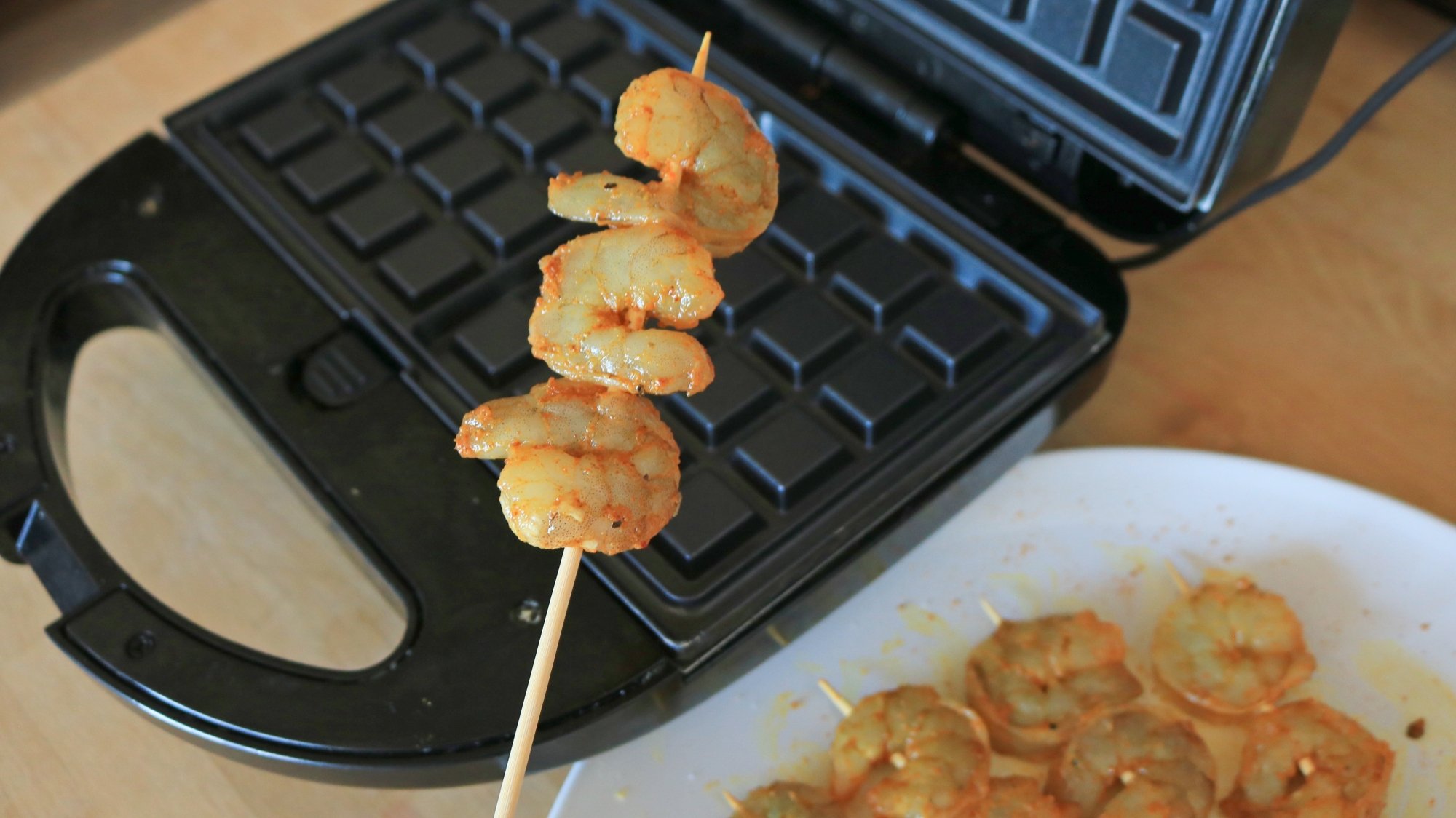 Raw shrimp on a skewer.