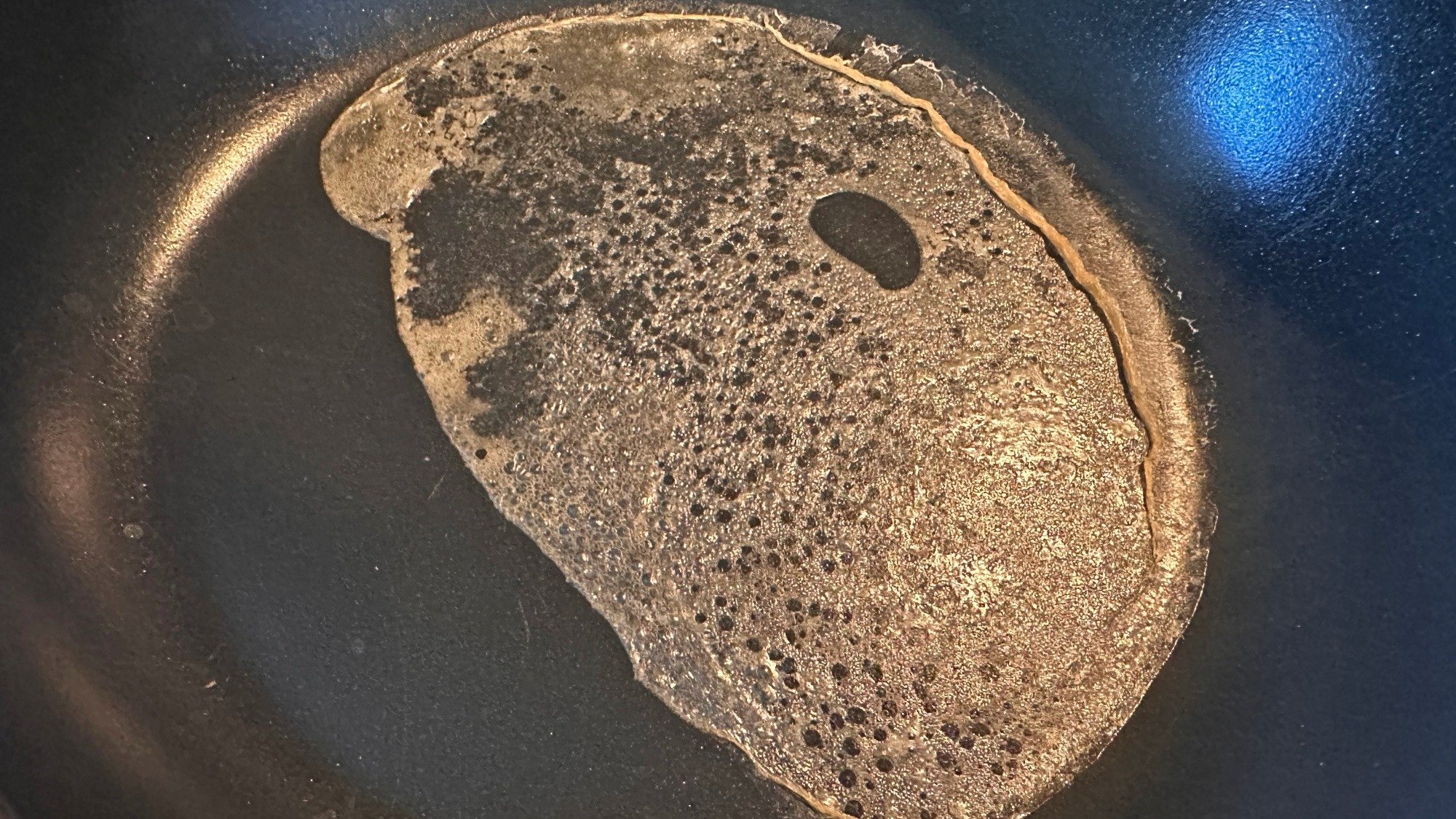 A thin sheet of liquid in a pan.