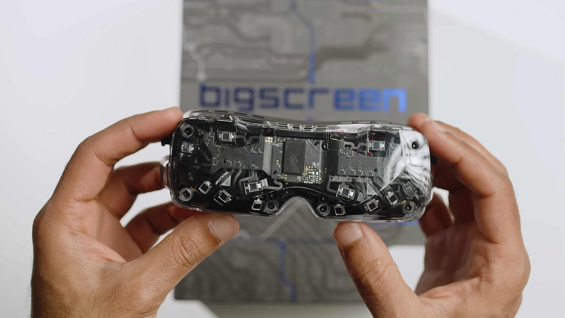 The Bigscreen Beyond 2 with transparent cover, held by two hands.
