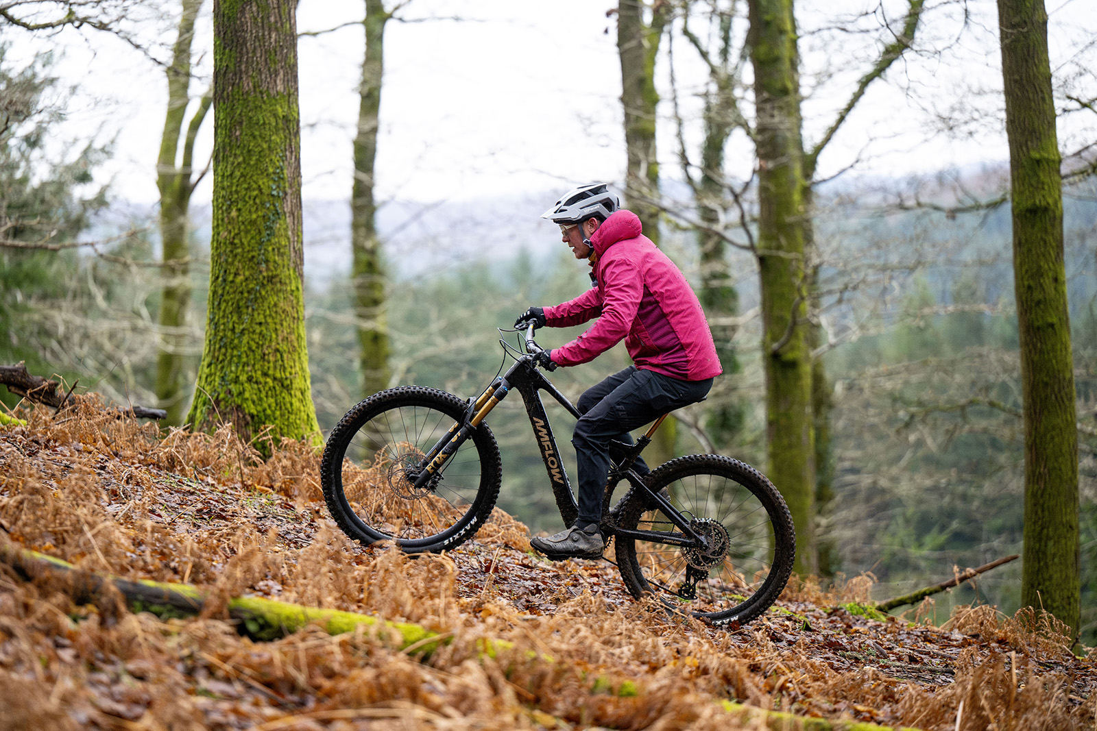Male rider in pink jacket riding the Avinox powered Amflow mountain eBike
