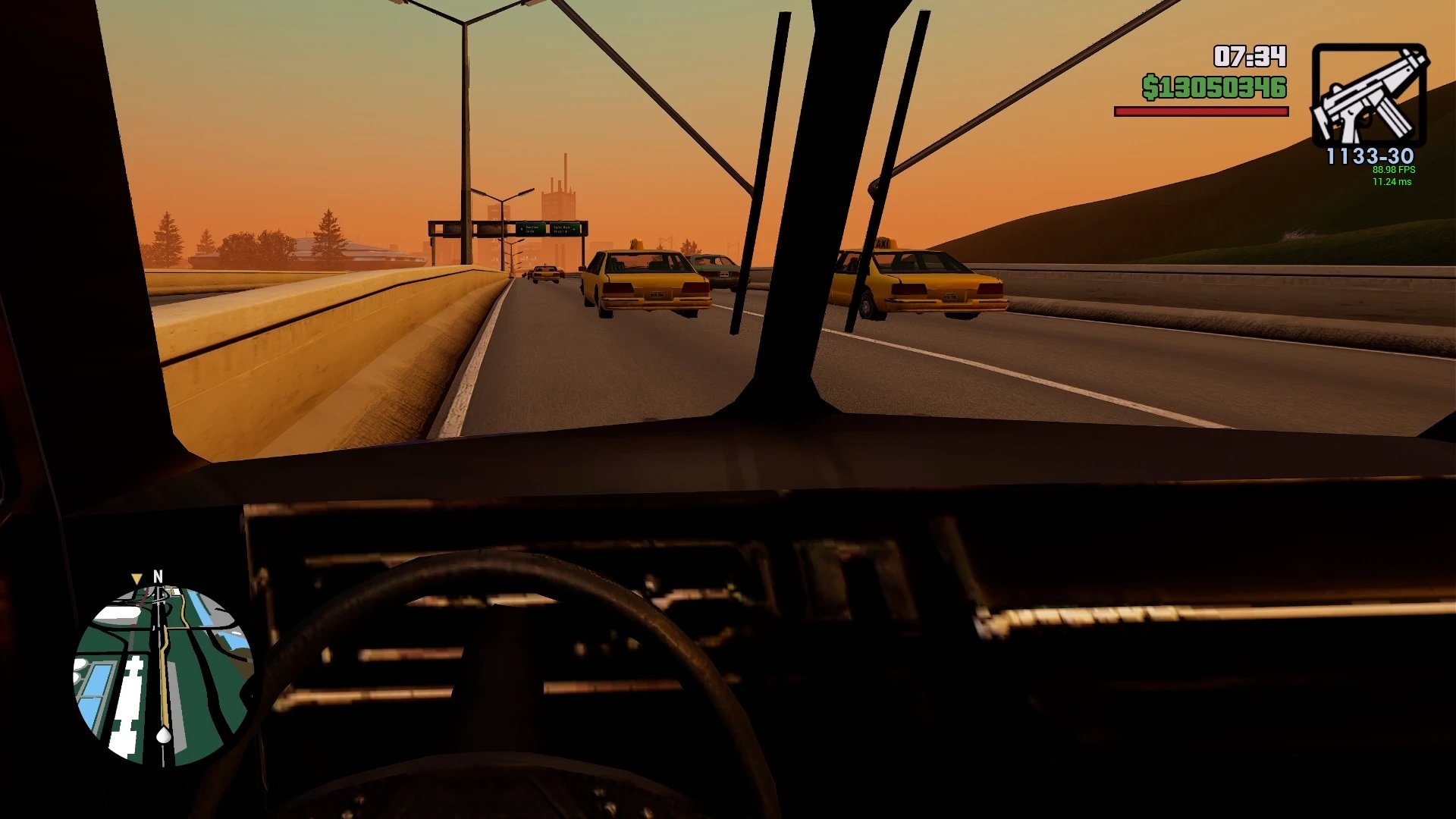 First-person perspective from a vehicle in GTA San Andreas. An orange skyline can be seen in the background.