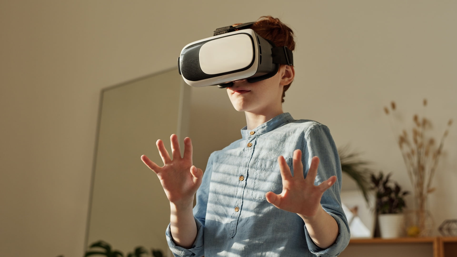 Child with VR glasses and defensive attitude