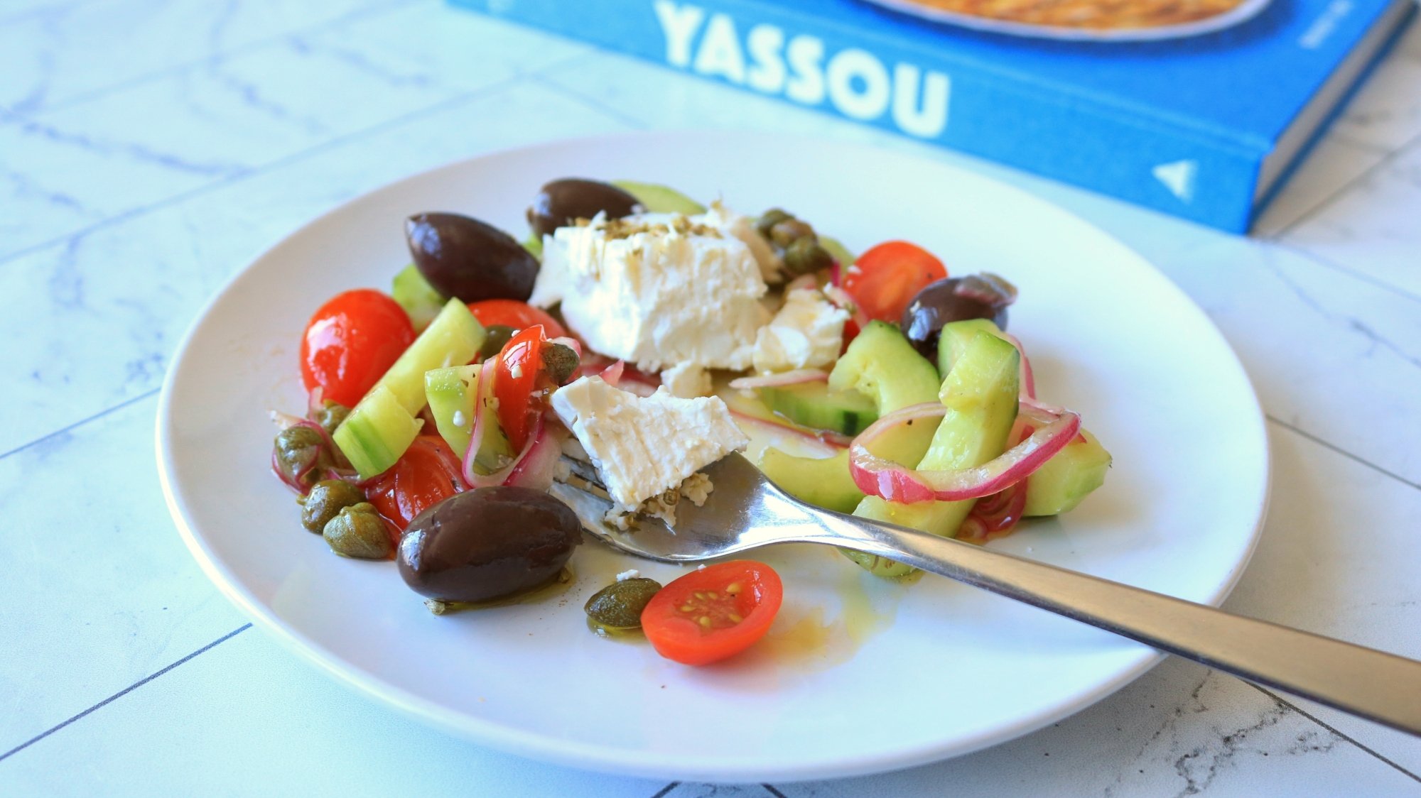 A Greek salad on a counter top.