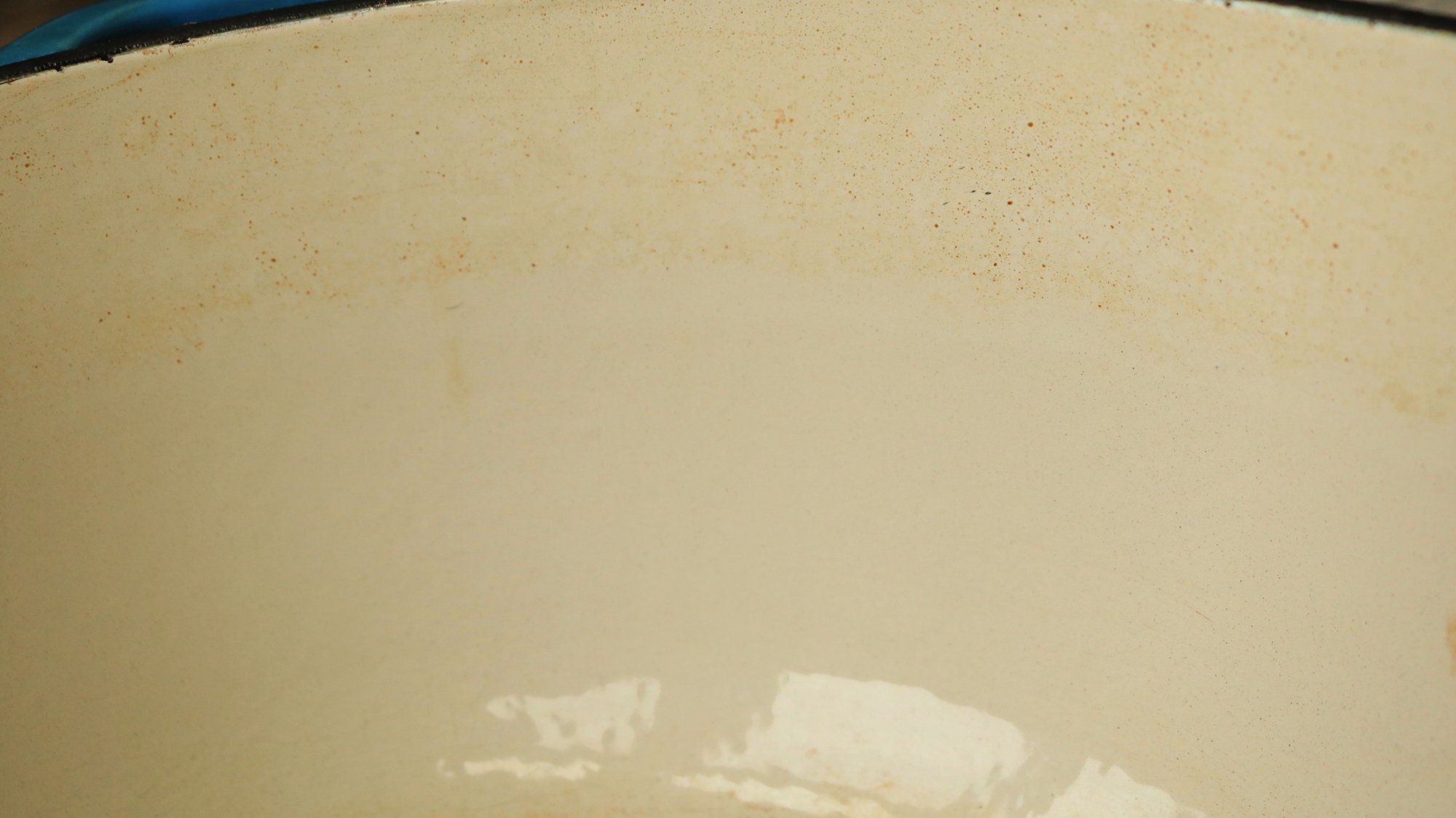 The inside of a Dutch oven with a faint stain line.