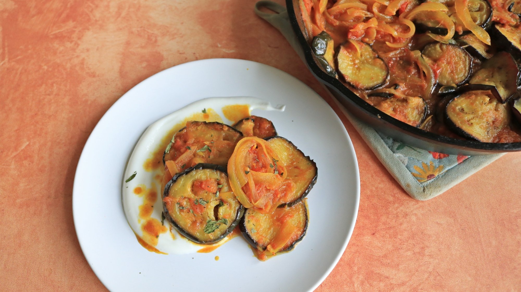 An eggplant dish on yogurt.