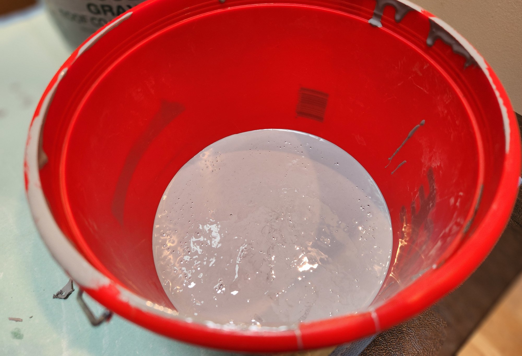 Revived paint in a red bucket.