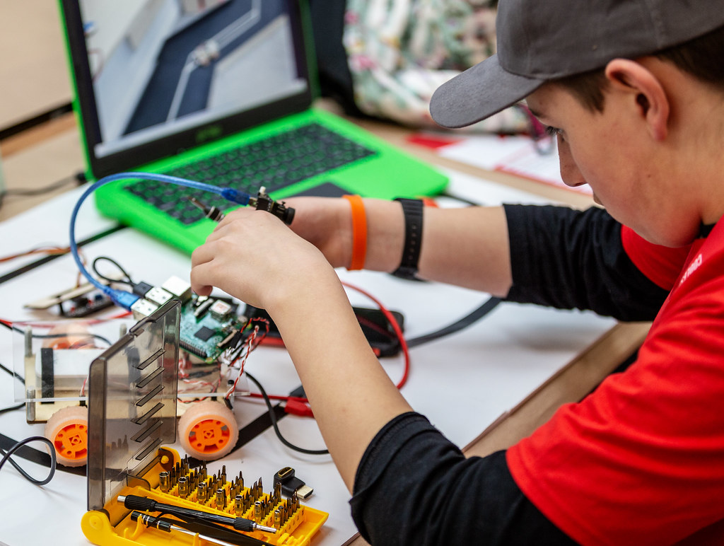 A young learner is building his project at a Coolest Projects event.