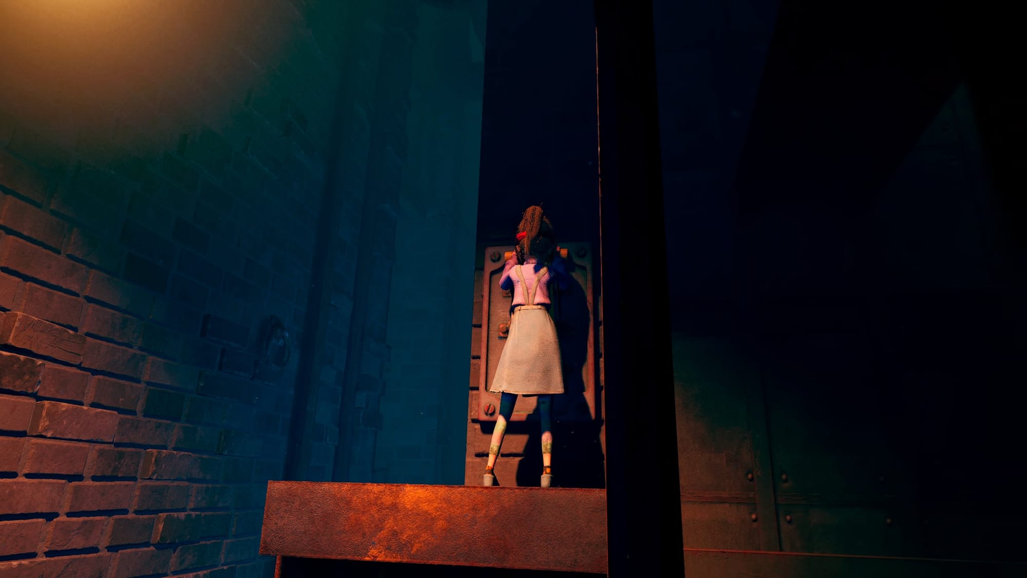 A young girl holding onto a device on a wall