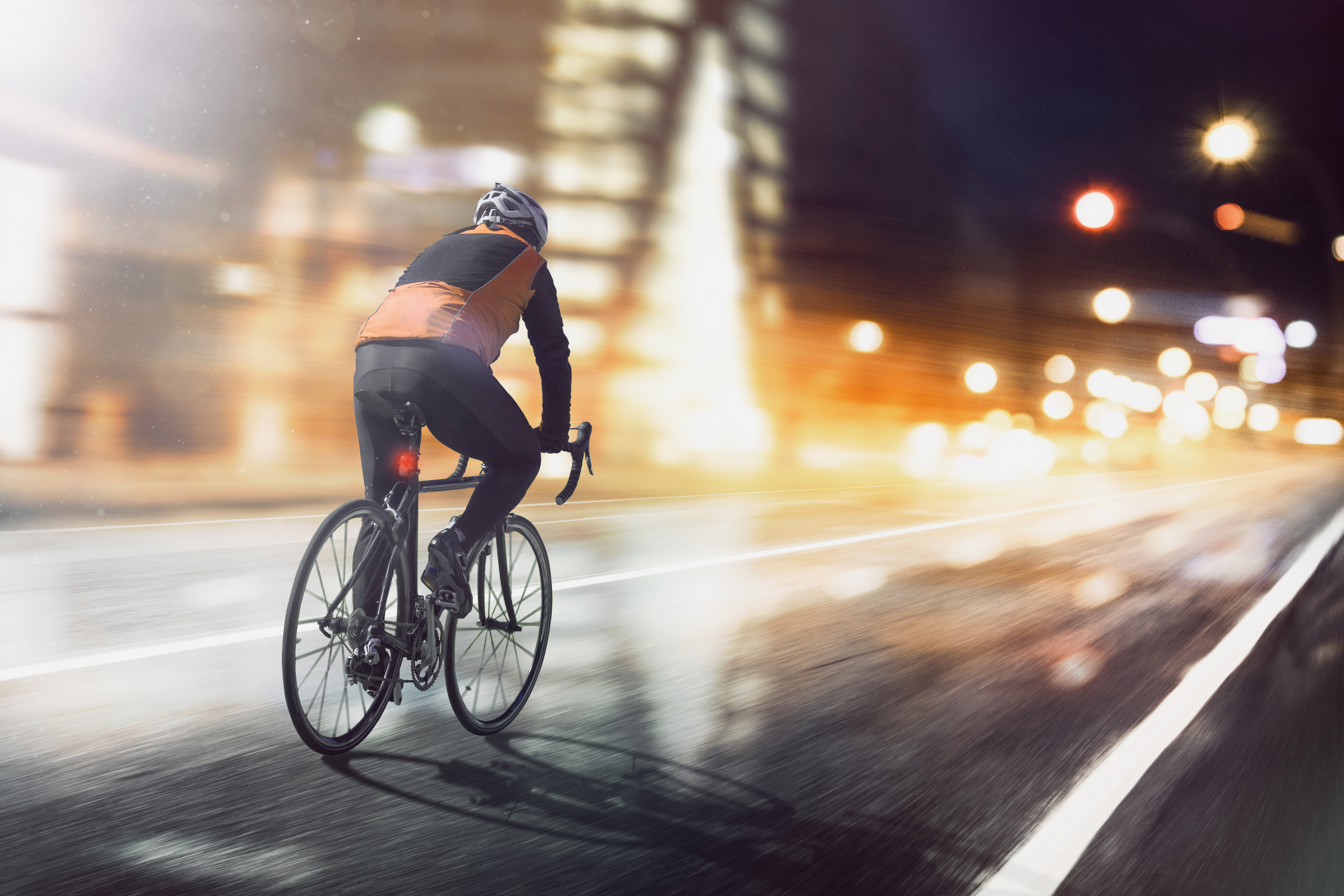 Cyclist rides through illuminated city Cyclist rides through illuminated city.