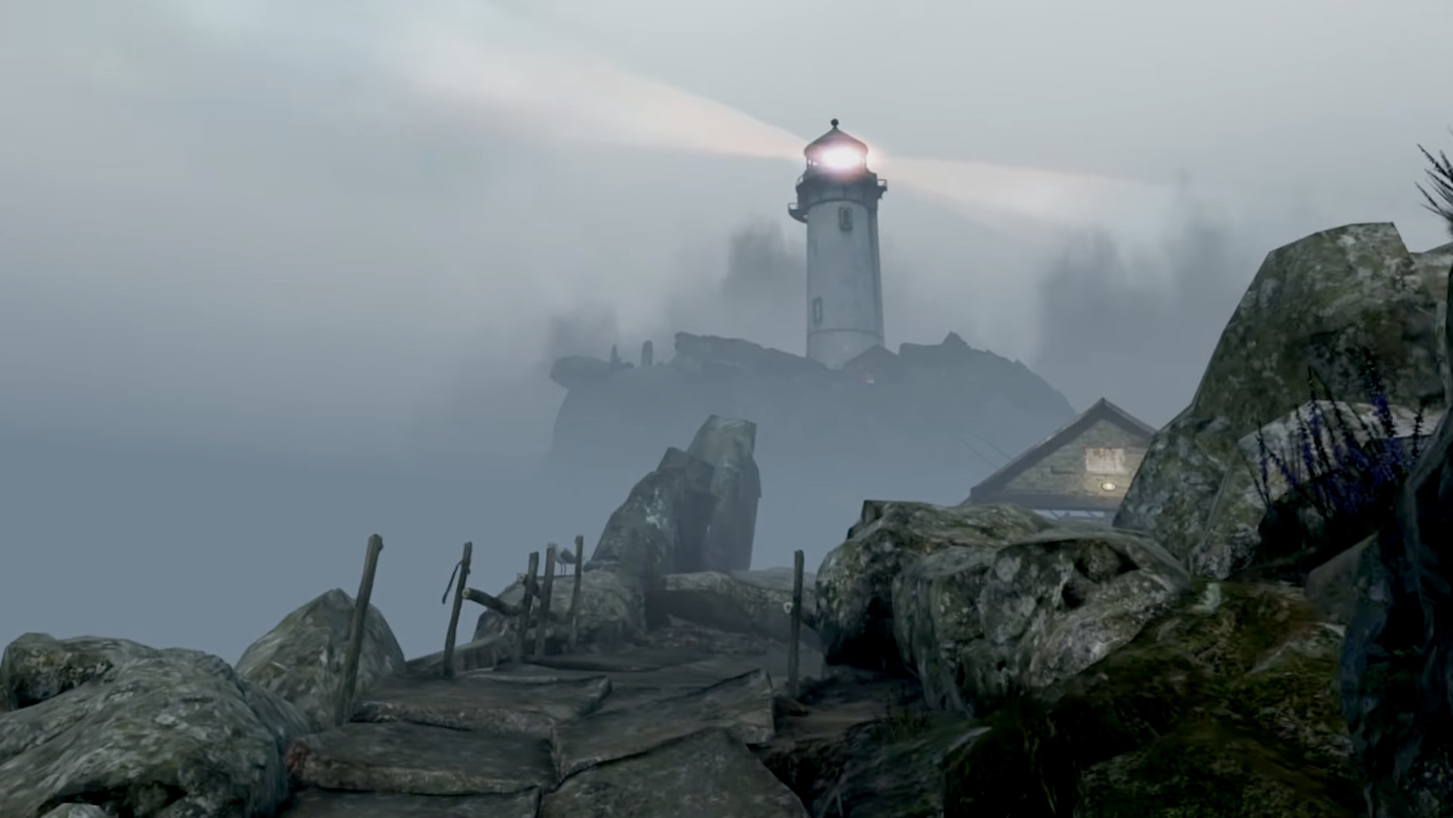 Fog-covered landscape with a lighthouse on a cliff and a small building in the foreground.