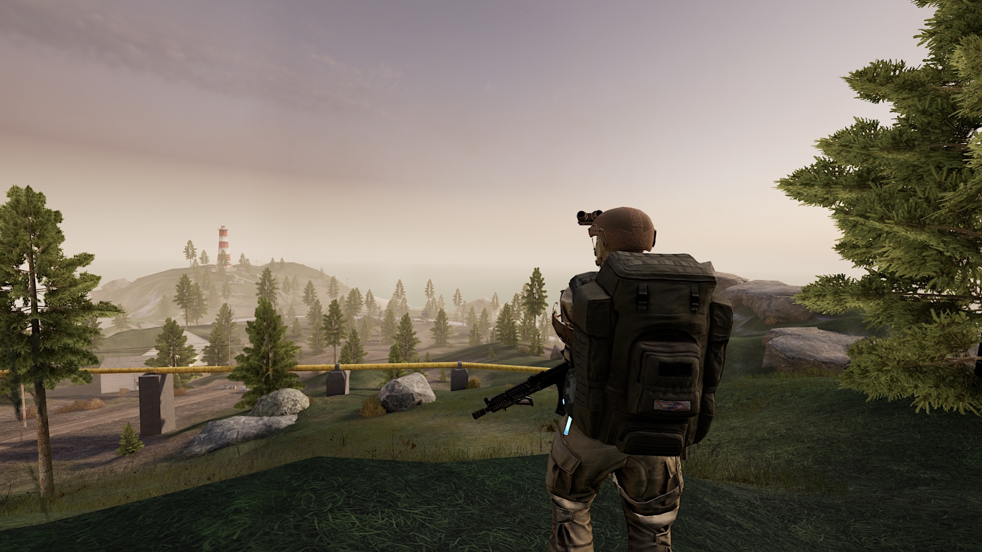 A mercenary stands on a hill with a heavy backpack and rifle, looking down on an island landscape.