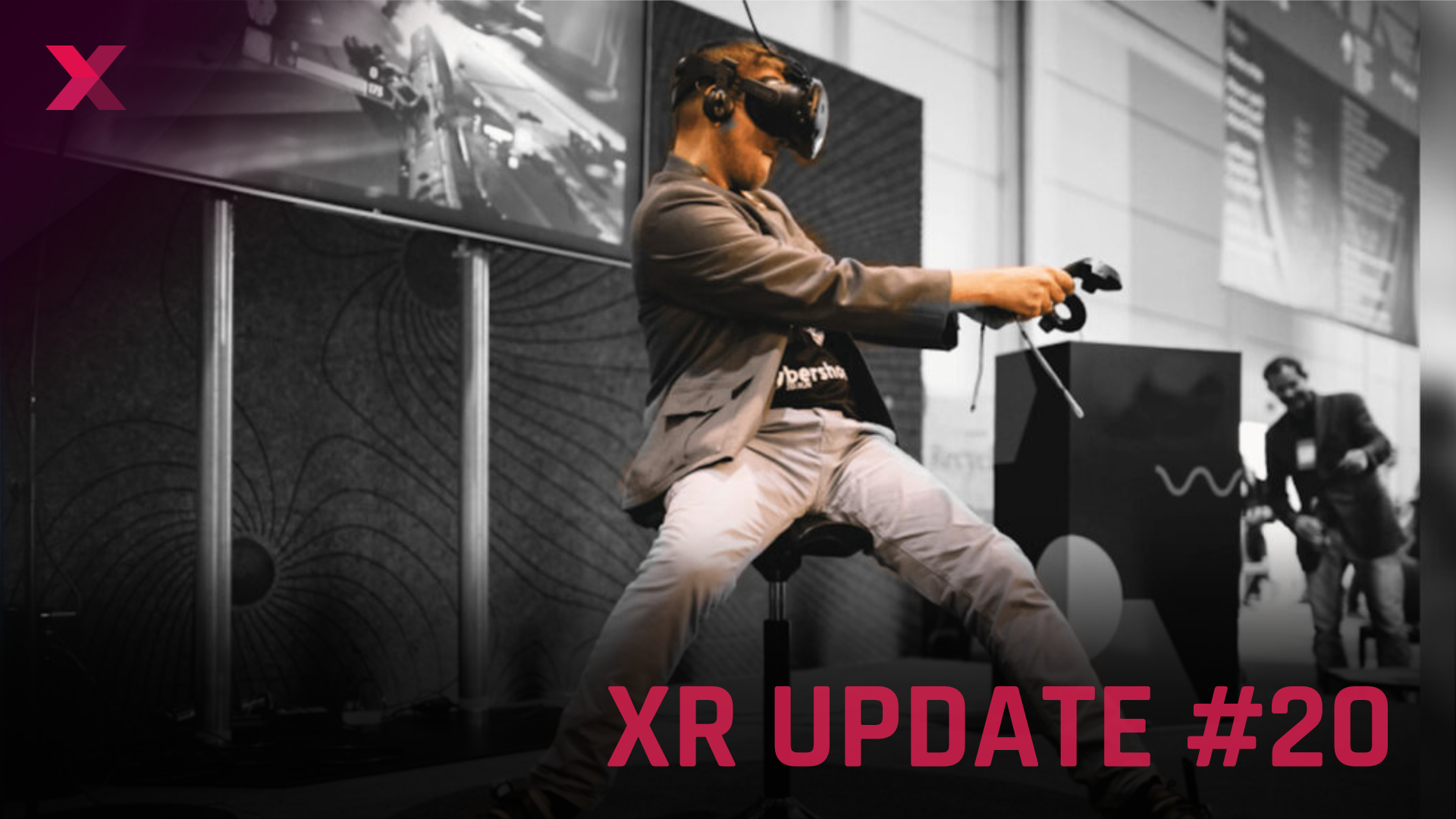A man sits on a stool and plays with a VR headset.