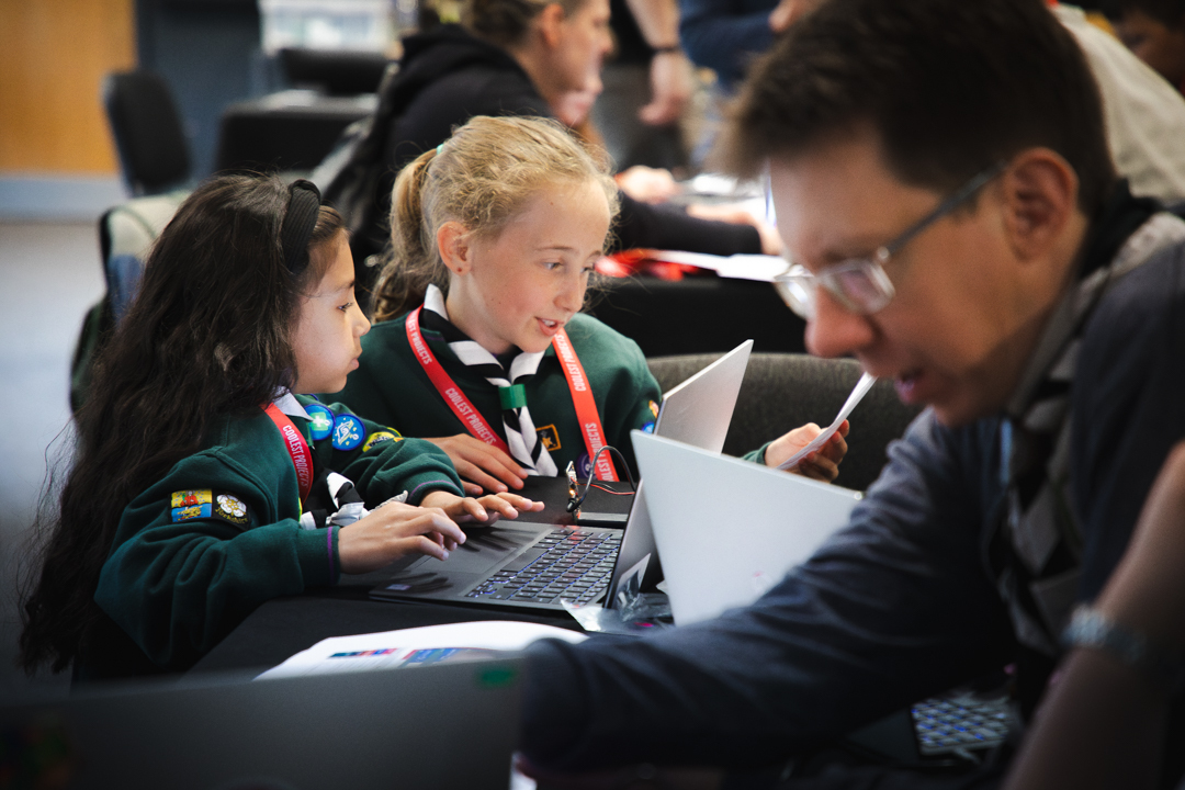 Two young scouts getting hands-on at a workshop.