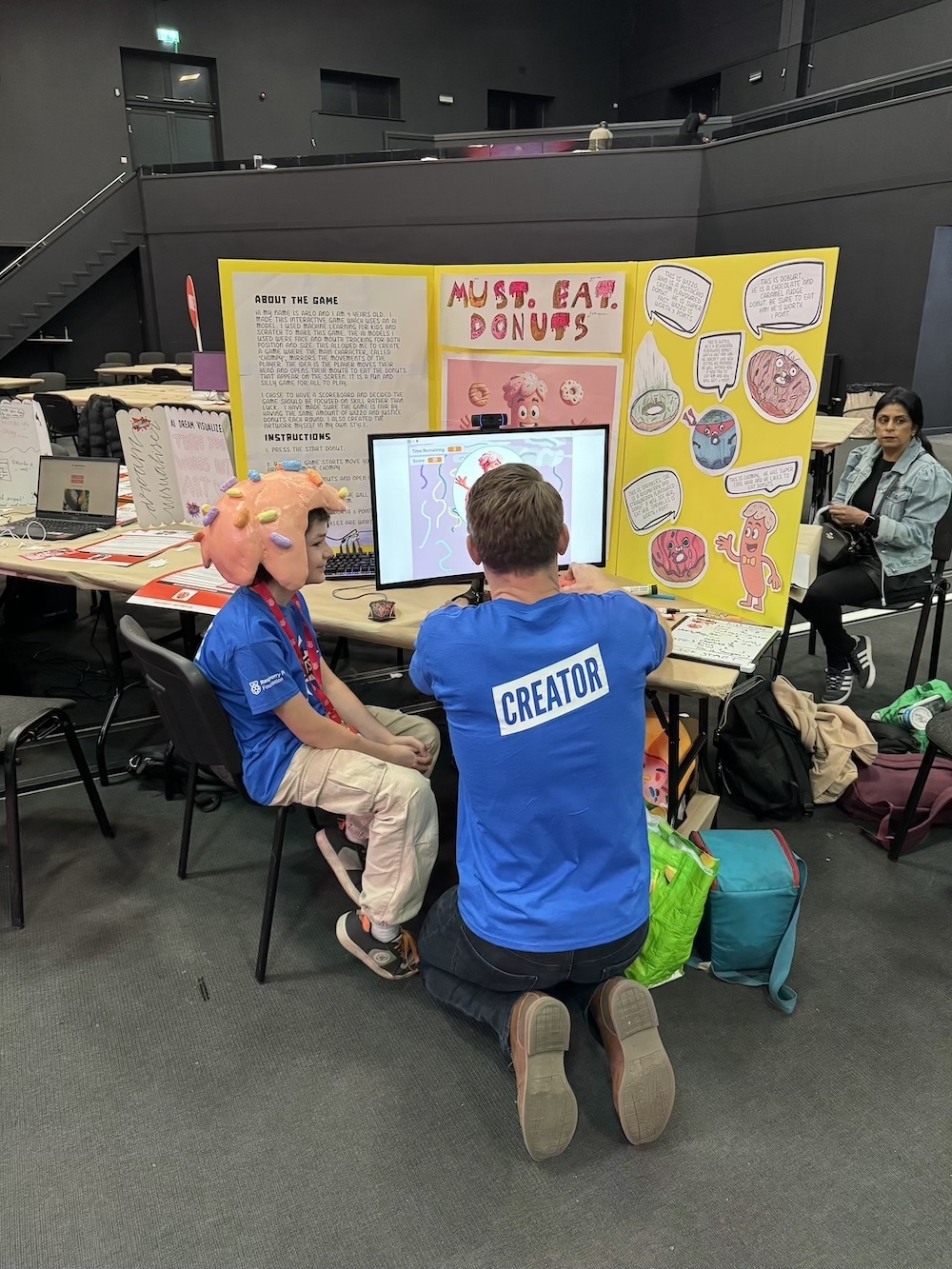 Arlo showing his project to the event host Greg Foot.