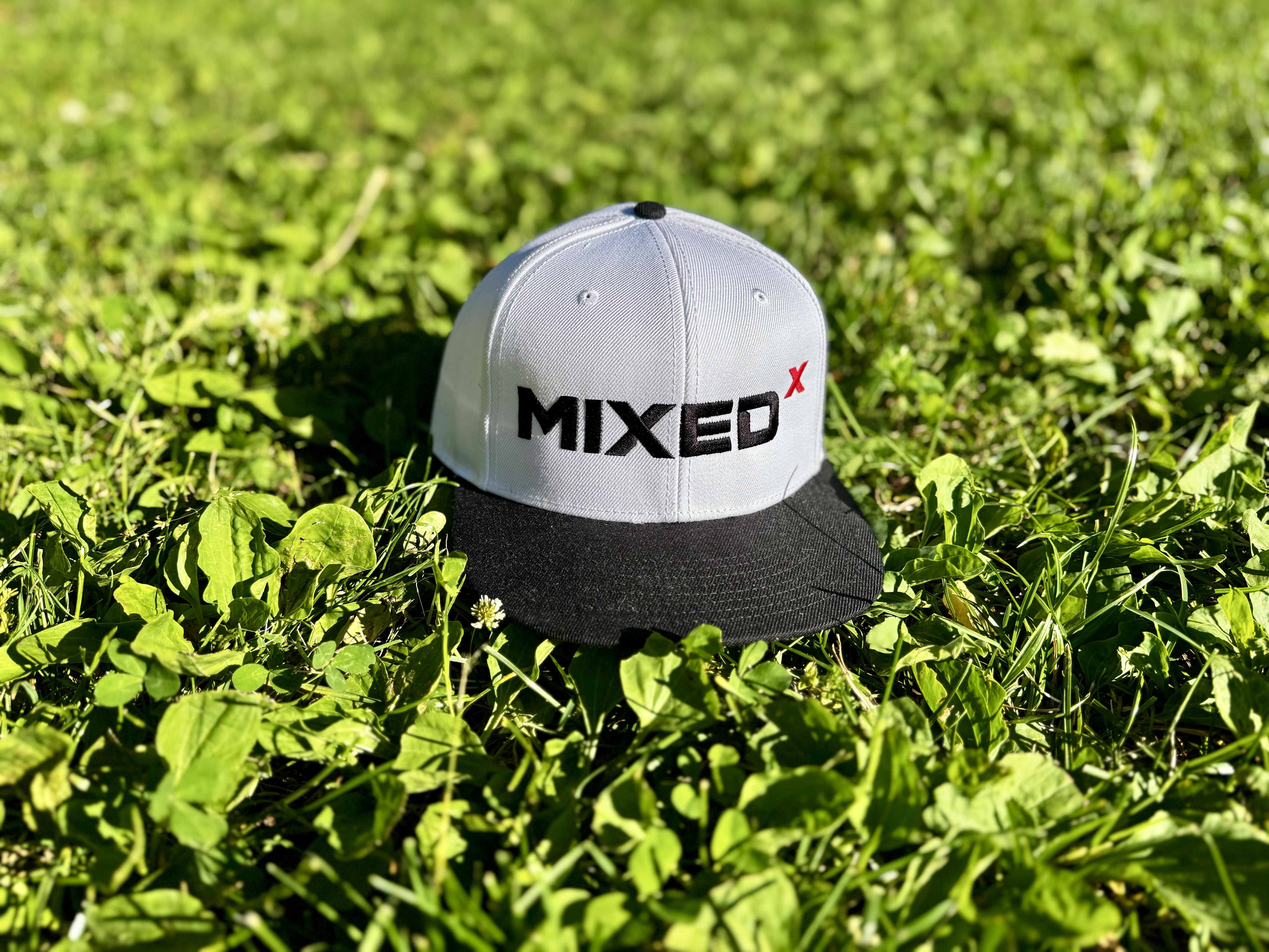MIXED Cap touching grass.