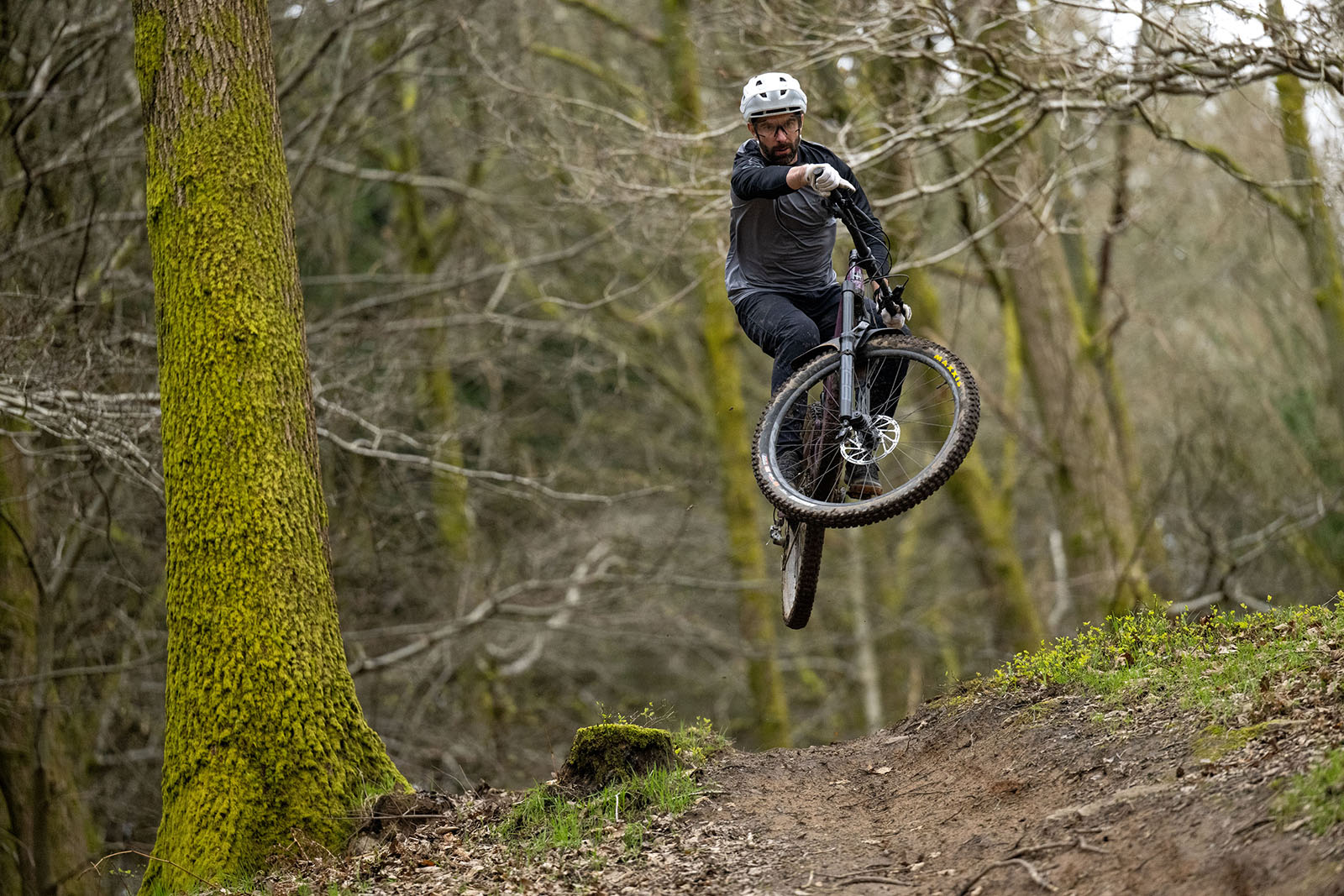 Male rider in grey and black top riding the Santa Cruz Megatower C R full suspension mountain bike