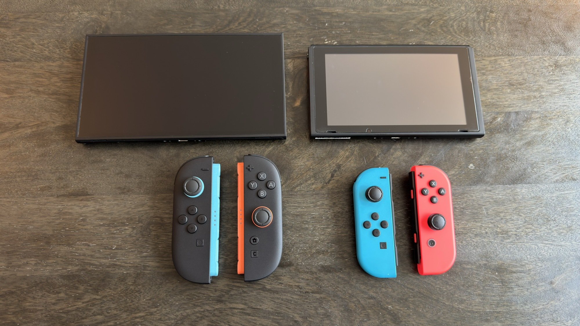 Switch 2 with joy-con 2 (left) next to Switch 1 with joy-con 1 (right)