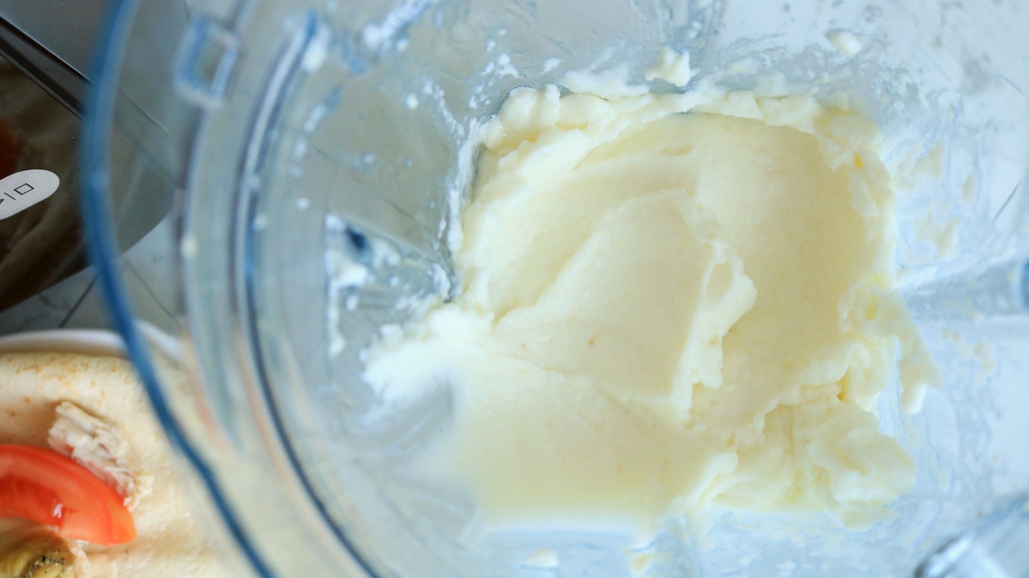 White aioli sauce in a blender.