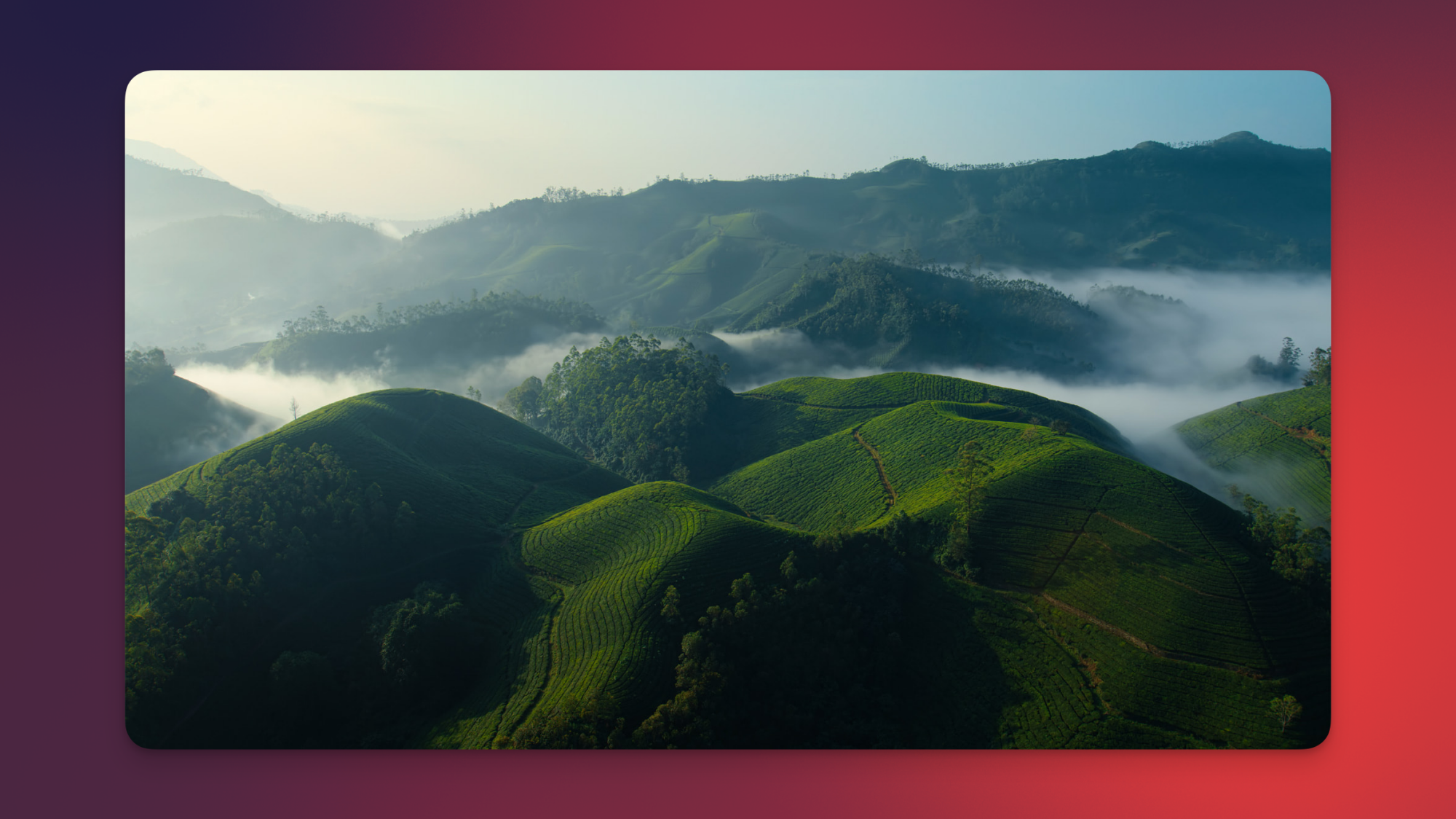 Apple TV's new India screensaver showing green hills among the clouds.